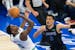 Timberwolves guard Anthony Edwards (5) attempts a fadeaway shot over Mavericks guard Josh Green (8) during the first quarter of Game 2 of the Western 