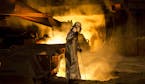 FILE -- A worker checks molten steel at one of the blast furnaces at the ArcelorMittal steelworks in Dunkirk, France, Feb. 18, 2014. The Trump adminis