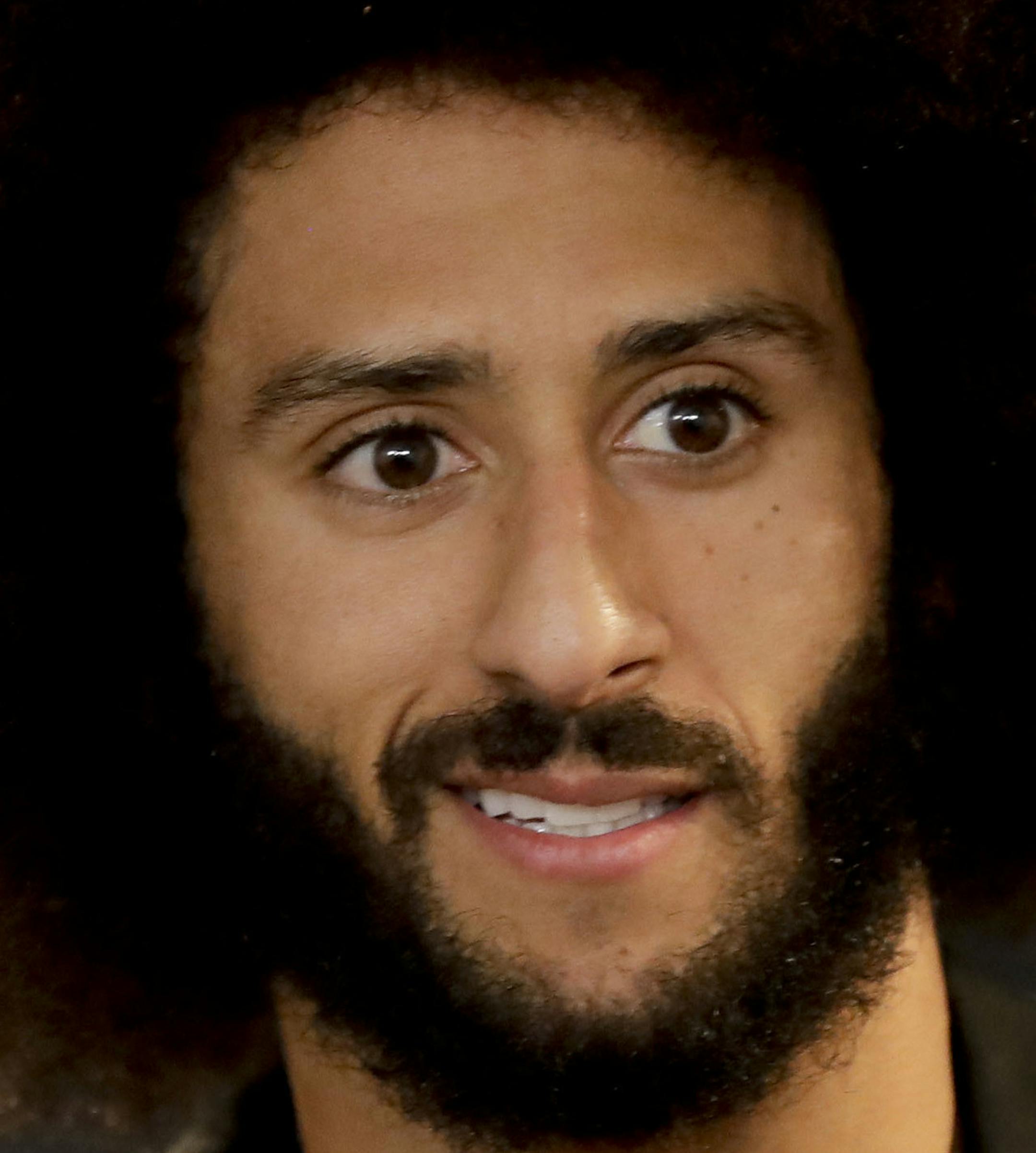 FILE - In this Dec. 24, 2016, file photo San Francisco 49ers quarterback Colin Kaepernick talks during a news conference after an NFL football game against the Los Angeles Rams. The free agent quarterback was named GQ magazine's "Citizen of the Year" for his activism on Nov. 13, 2017. (AP Photo/Rick Scuteri, File)