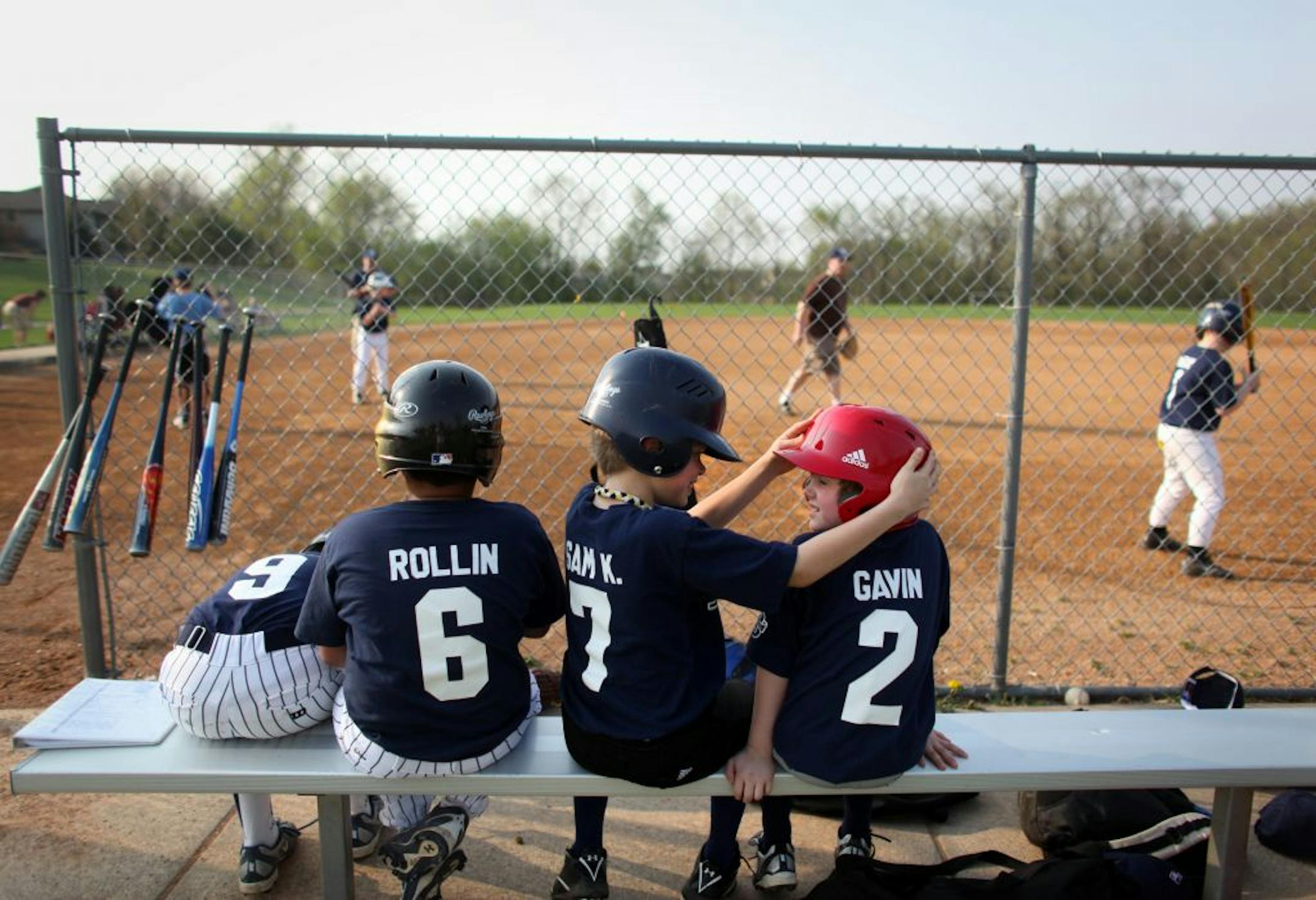 Sam Keefe, center, chatted with Gavin Williams as they waited to bat during a squirts game at O'Connell Park in Savage on Tuesday. Savage has 31.5 percent of its residents age 18 or younger, among the 10 highest percentages in the metro area.