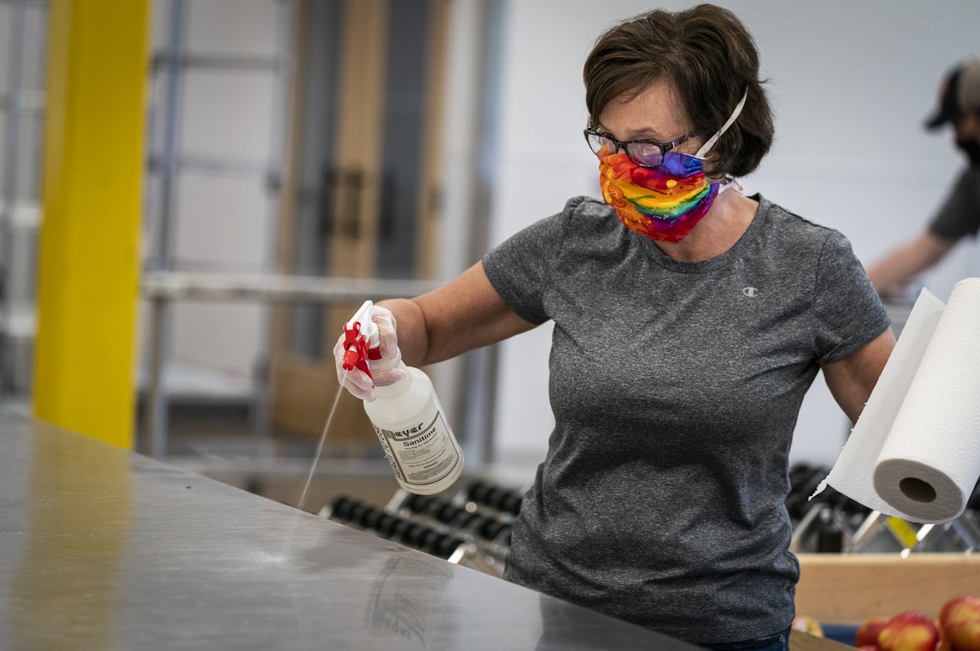 A volunteer sanitized her workspace after a shift at Second Harvest Heartland in Brooklyn Park.