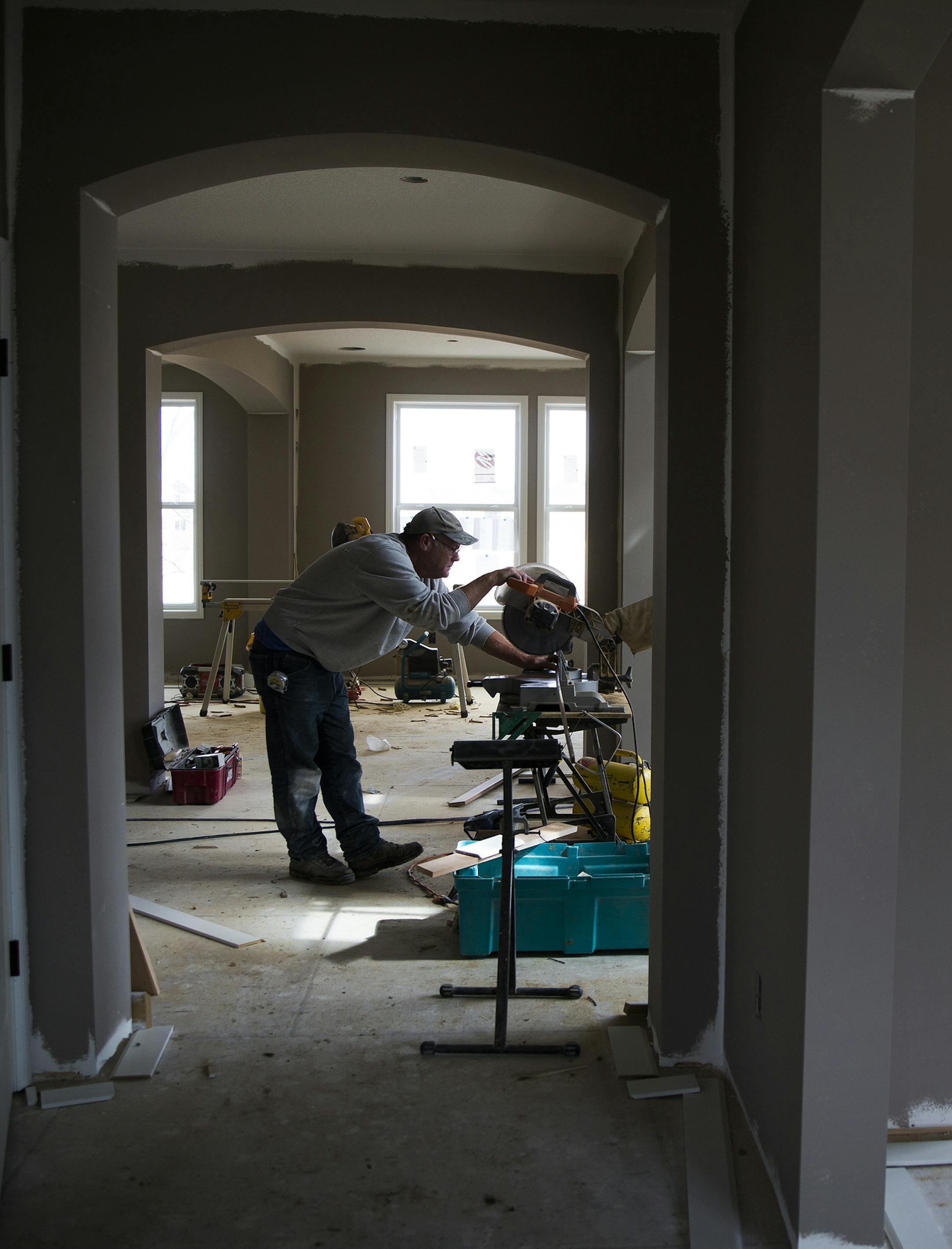 Trim carpenter Mike Horsch works to build a home in the new Lennar Homes development called The Reserve at Spring Meadows in Plymouth on Thursday, March 26, 2015. ] LEILA NAVIDI leila.navidi@startribune.com /