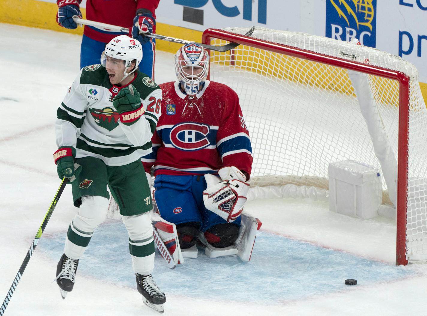 Minnesota Wild center Connor Dewar (26) celebrates his goal over Montreal Canadiens goaltender Sam Montembeault (35) during the first period of an NHL hockey game, Tuesday, Oct. 17, 2023 in Montreal. (Christinne Muschi/The Canadian Press via AP)