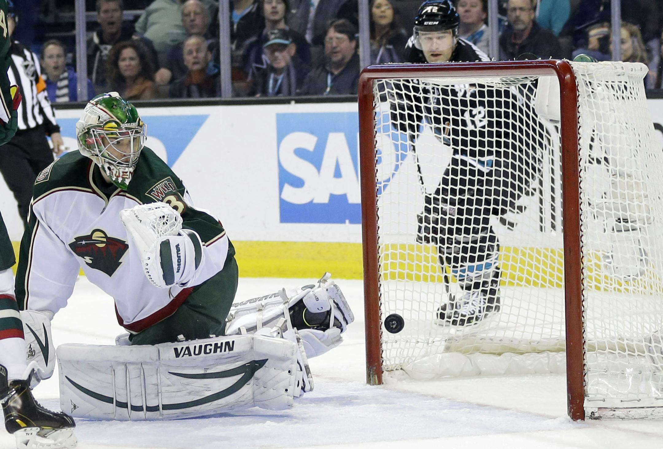 Minnesota Wild goalie Darcy Kuemper is beaten for a goal on a shot from San Jose Sharks center Logan Couture during the third period of an NHL hockey game in San Jose, Calif., Thursday, April 18, 2013. (AP Photo/Marcio Jose Sanchez)