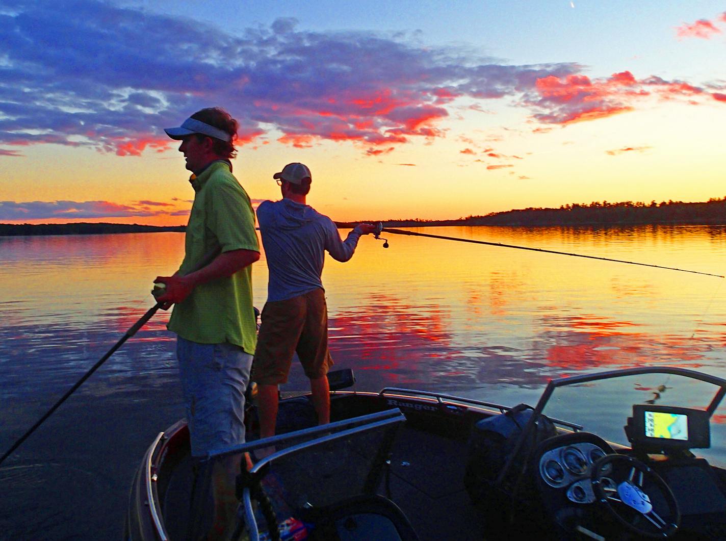 Trevor Anderson, left, and Dominic Schneider cast during sunset, which often offers the best conditions, during their Lake of the Woods trip.