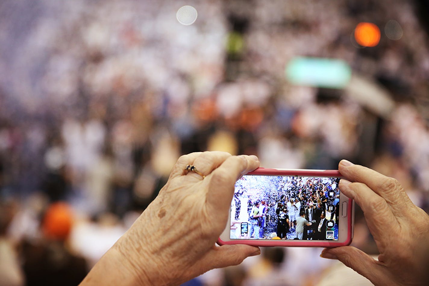 A fan records with her phone as the Minnesota Lynx celebrate winning the WNBA title.