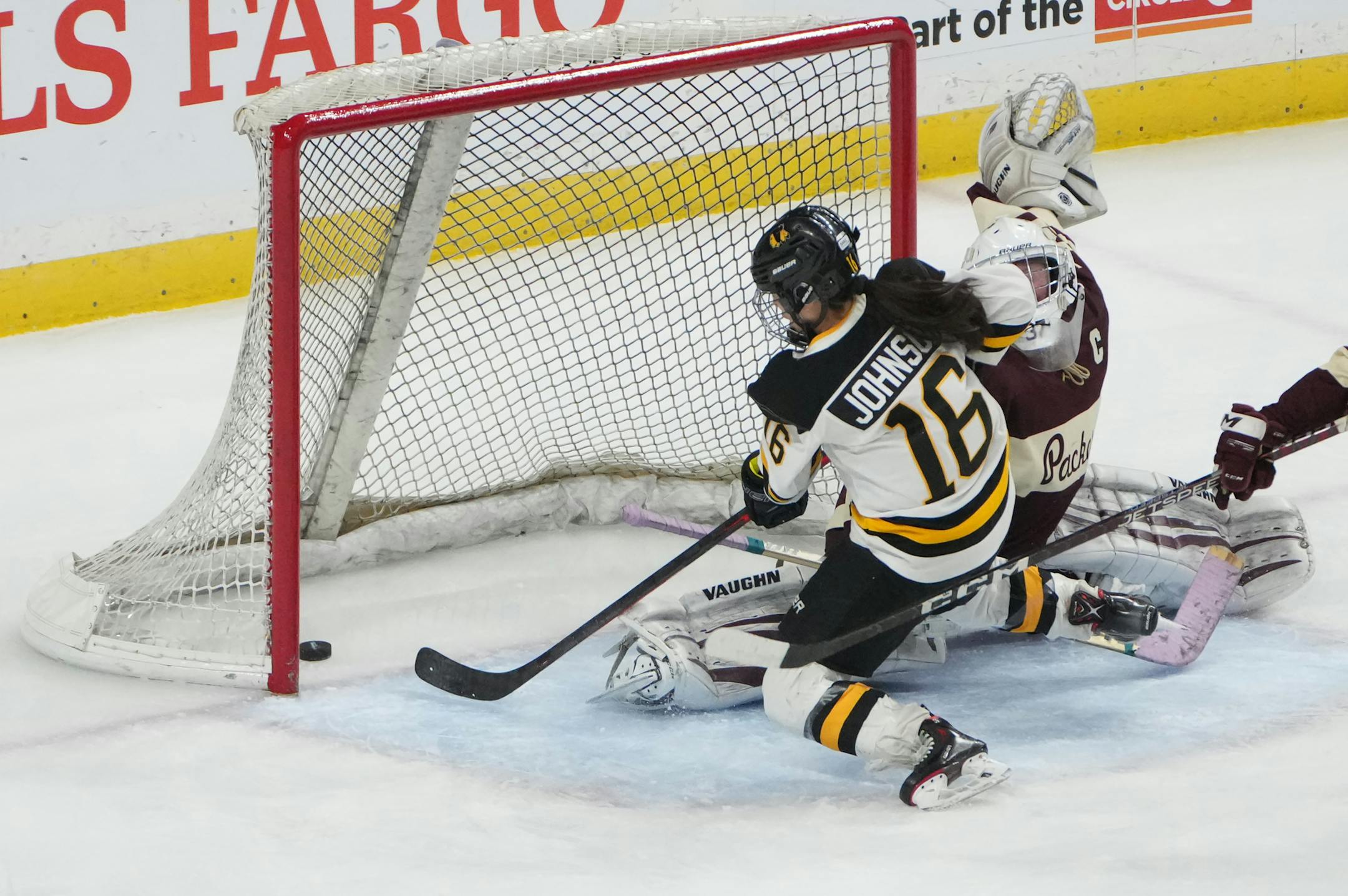 Warroad forward Kate Johnson (16) gets the puck past South St. Paul goaltender Delaney Norman (37) in the third period.