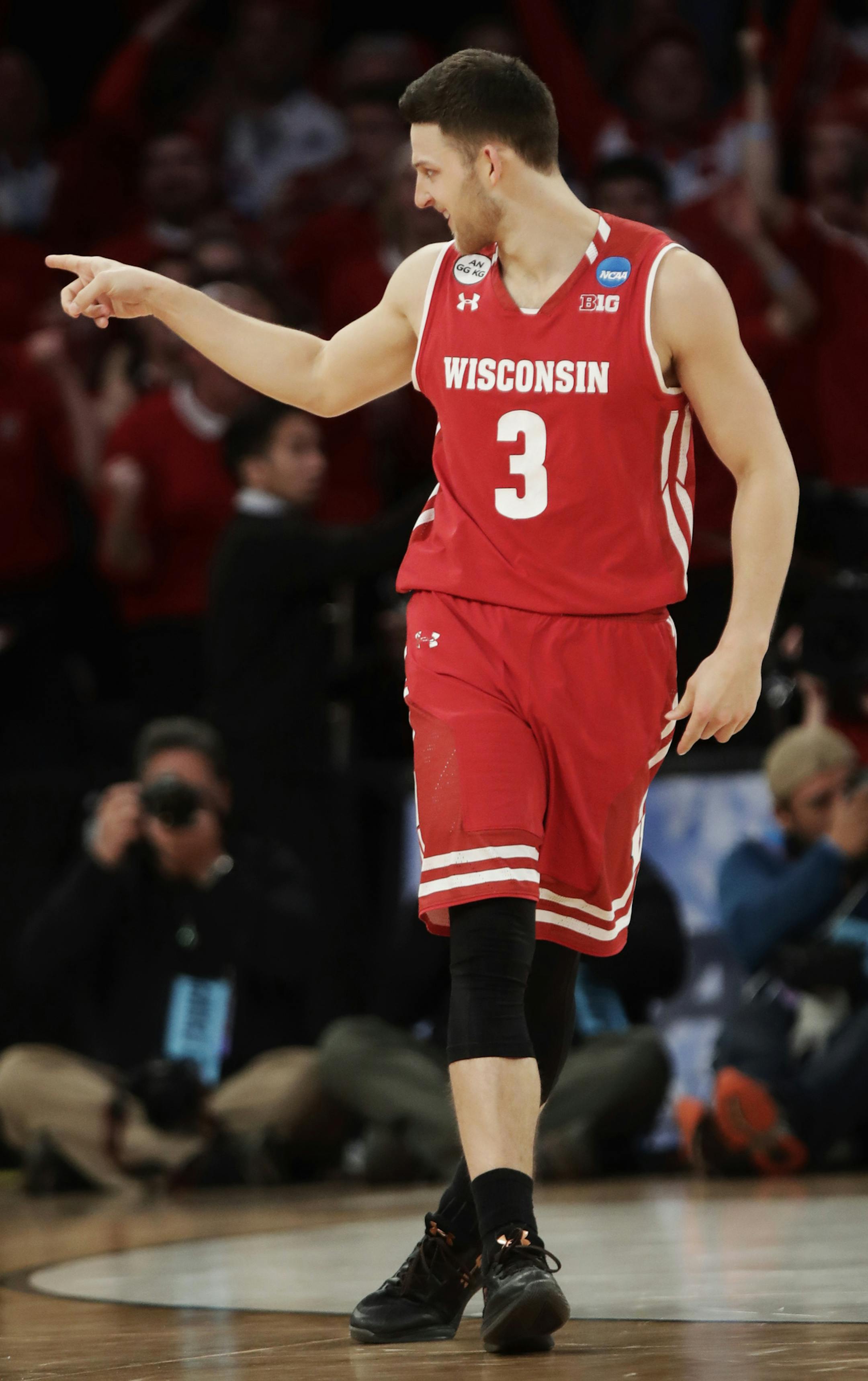 Wisconsin guard Zak Showalter (3) points to fans in the stands after hitting a 3-point shot to tie the game against Florida late in the second half of an East Regional semifinal game of the NCAA men's college basketball tournament, Saturday, March 25, 2017, in New York. (AP Photo/Frank Franklin II)