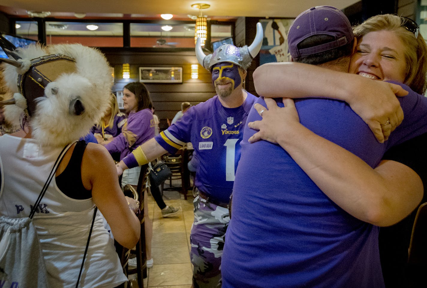 Scott &#x201c;Skolt&#x201d; Asplund, center, and Cyrea Lynch, left, joined fans at Jake&#x2019;s Stadium Pizza in Mankato. The city is losing the Vikings training camp and its ties with its favorite team.