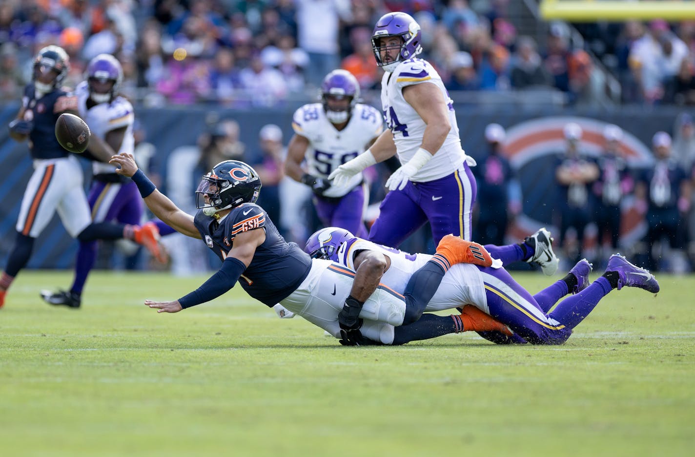 Chicago Bears quarterback Justin Fields (1) is sacked by Danielle Hunter (99) of the Minnesota Vikings in the third quarter Sunday, October 15, 2023, at Soldier Field in Chicago, Ill. ] CARLOS GONZALEZ • carlos.gonzalez@startribune.com