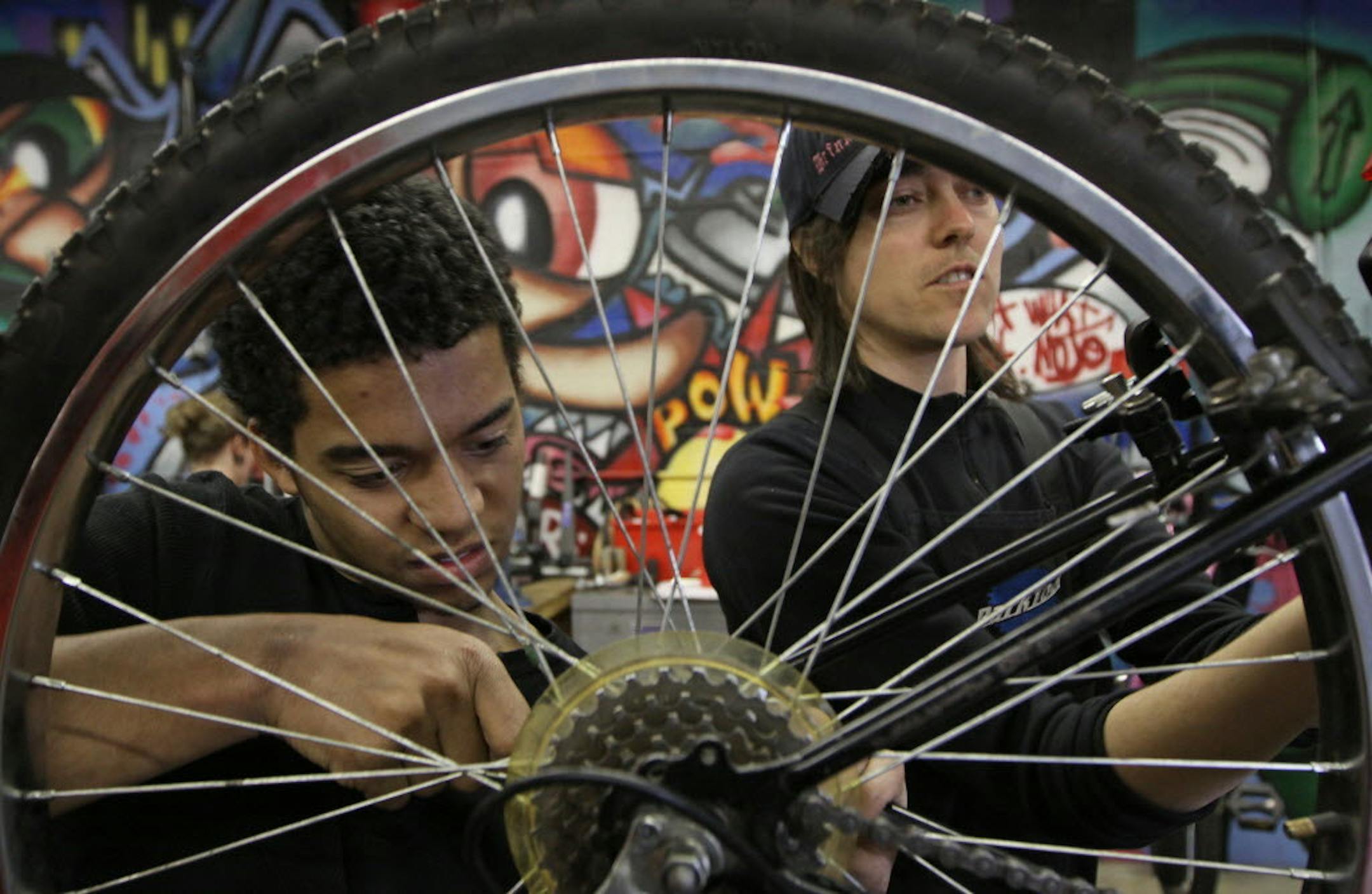 Bike work being done at the non-profit business that repairs and sells used bikes, and helps homeless young men get assistance.
