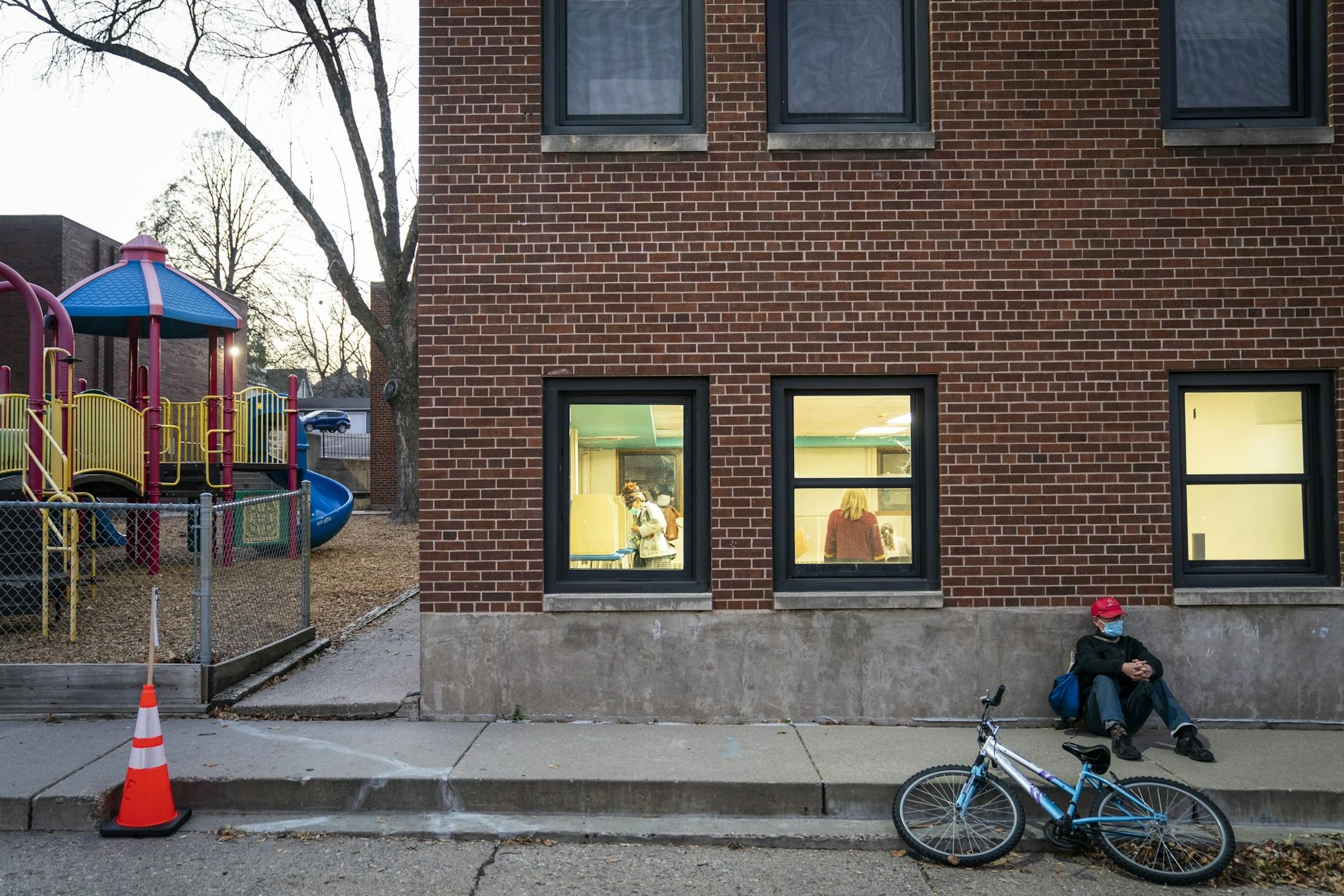 Voters inside St. Matthews Social Hall in St. Paul are seen from the outside of the building.