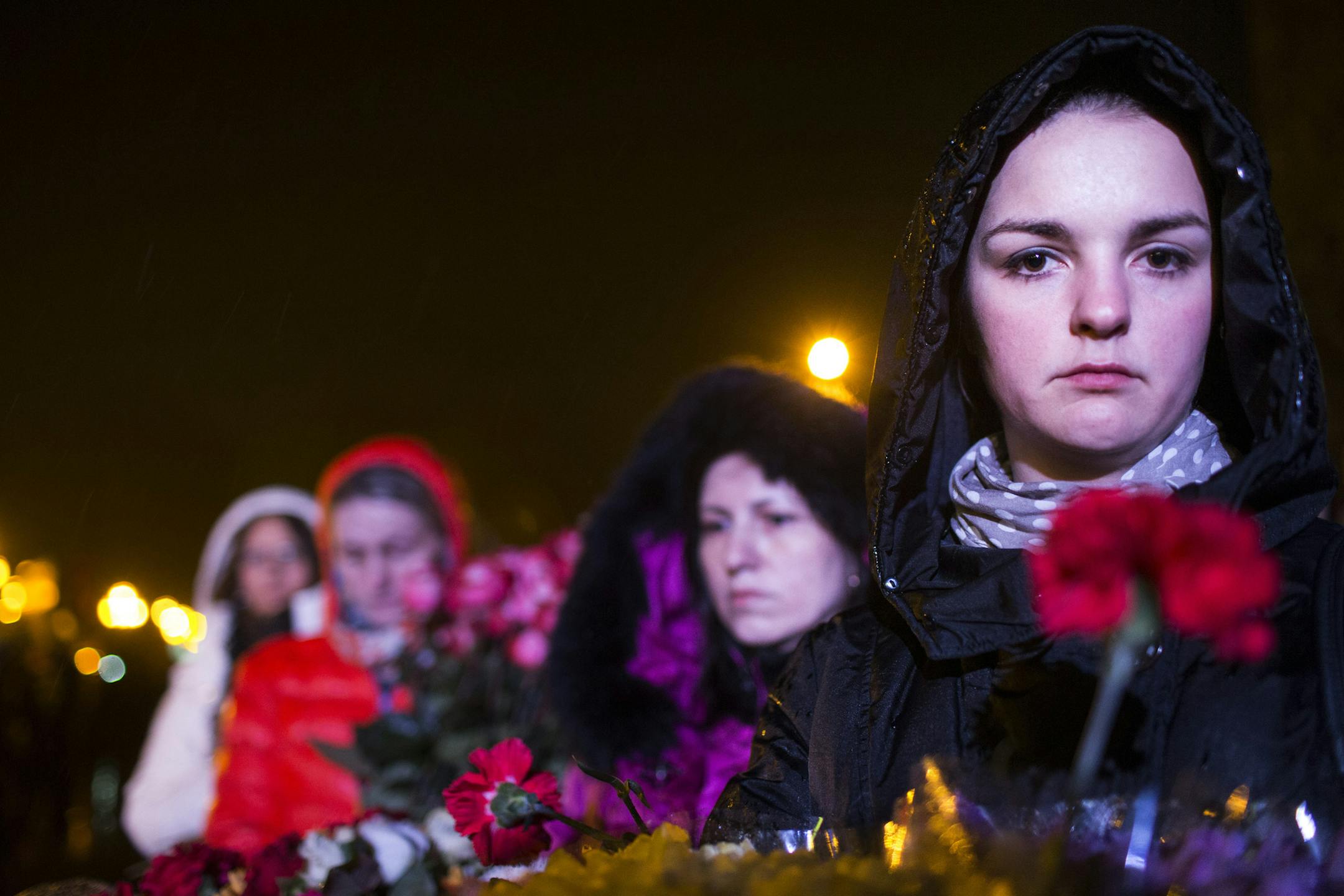 Mourners with bundles of flowers gather early in the morning around the coffins of two victims of the violent demonstrations in Kiev, in the city square of the western city of Lviv, Ukraine, Feb. 22, 2014. Opposition leaders reportedly agreed to President Viktor Yanukovych's offer of concessions including early elections and constitutional changes to roll back executive powers, a day after a drastic escalation in the conflict between protesters and riot police left dozens dead. (Uriel Sinai/The