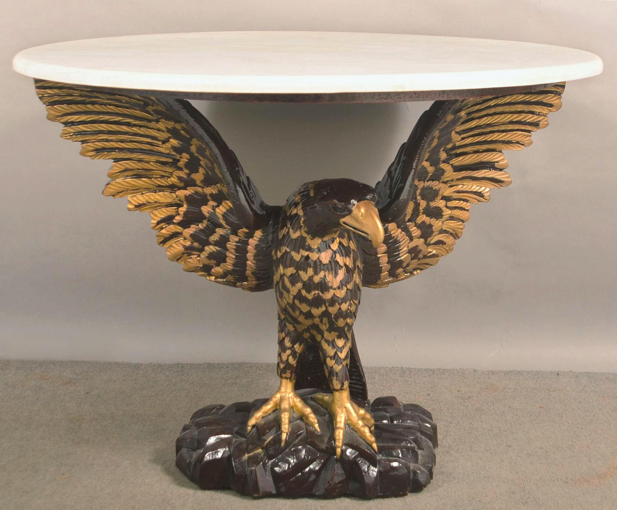 Eagles are a powerful symbol in American designs from the Great Seal to everyday decorative arts. A carved eagle holds up this table's faux marble top. by Cowles Syndicate