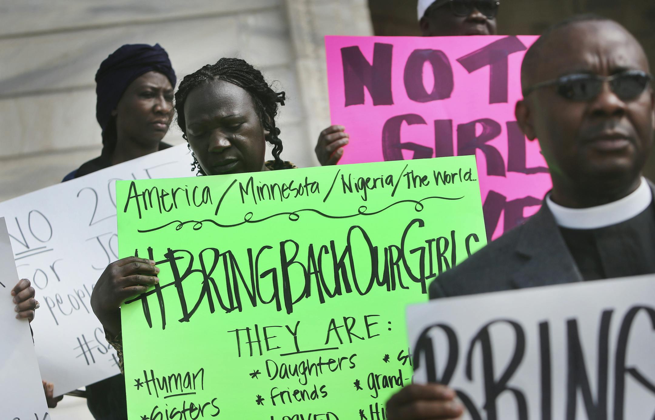 Larai Dahip, center, of Coon Rapids joined other Nigerian Americans during a protest against the abduction of more than 250 young Nigerian girls from a school by the terrorist group Boko Haram Friday, May 9, 2014, at the State Capitol in St. Paul, MN. Dahip has tribal scarring on her face, not atypical for some people living in Nigeria. Some of the protestors said they believed some of the girls abducted were marked with tribal scarring.](DAVID JOLES/STARTRIBUNE) djoles@startribune Galvanize and