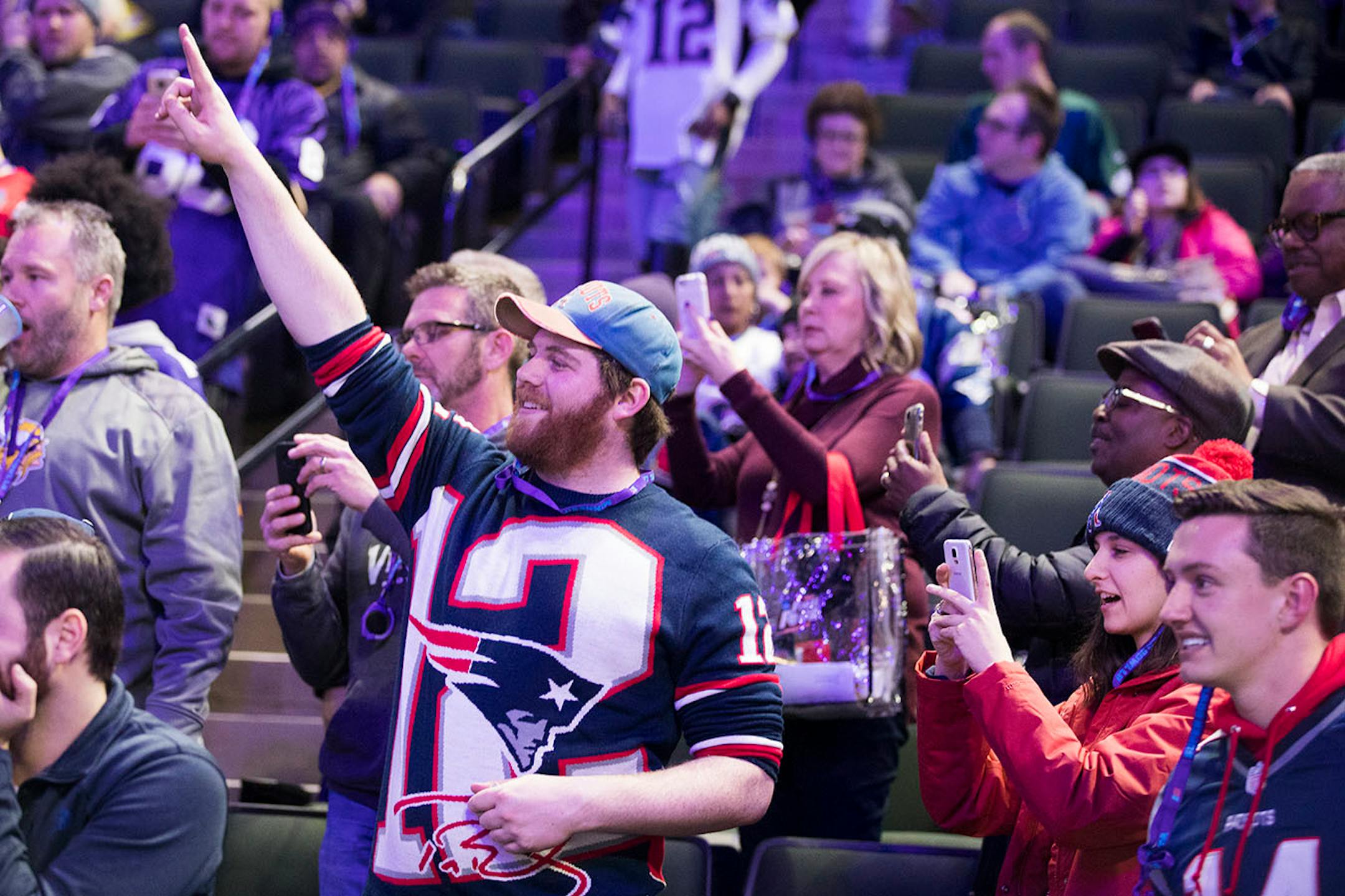 Patriots fans wave to the cameras.
