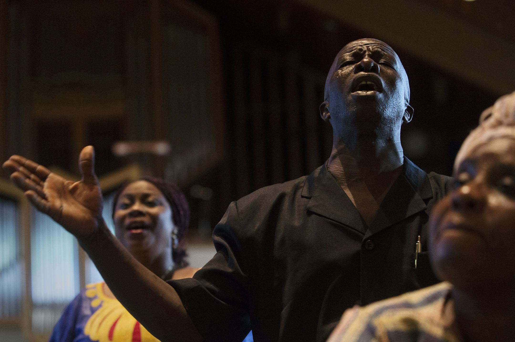 From left, Rev. Earlyn Manlay, of Crystal, Pastor P. Gabriel Sieh Sr., of Liberia, and Marie Vah, of Brooklyn Park, prayed during the "prayer for ebola eradication from West Africa" at the Liberian 168th Independence Day celebration and "Ebola Thanksgiving & Intercessory Prayer Service" in Brooklyn Center, Minn., on Sunday July 26, 2015. ] RACHEL WOOLF · rachel.woolf@startribune.com