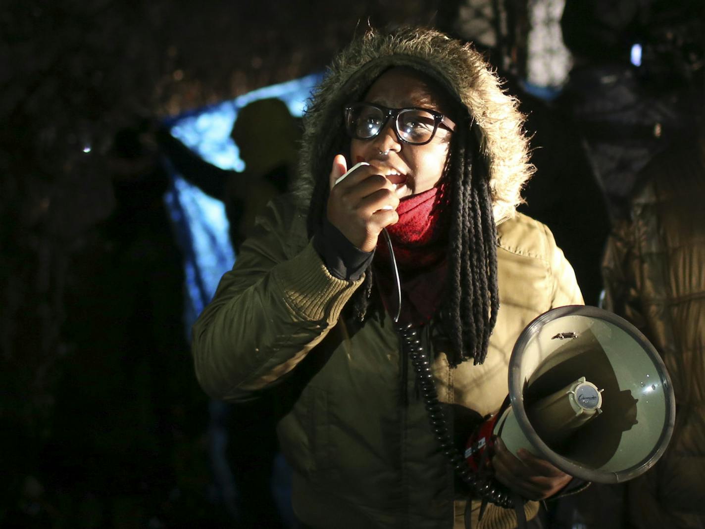 A Black Lives Matter demonstrator led chants with a megaphone as protesters blocked a rear entrance to the 4th Precinct station Wednesday night in Minneapolis. ] JEFF WHEELER &#xef; jeff.wheeler@startribune.com Black Lives Matter and others have held a continuous protest at the Minneapolis Police 4th Precinct station, including Wednesday night, November 18, 2015 after a man was shot by Minneapolis police early Sunday morning, ORG XMIT: MIN1511182013110645