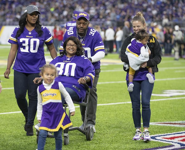Minnesota Vikings fullback C.J. Ham's mother Tina, surrounded by his family, was honored during half time. Sister (far left), father Cortez, wife Step