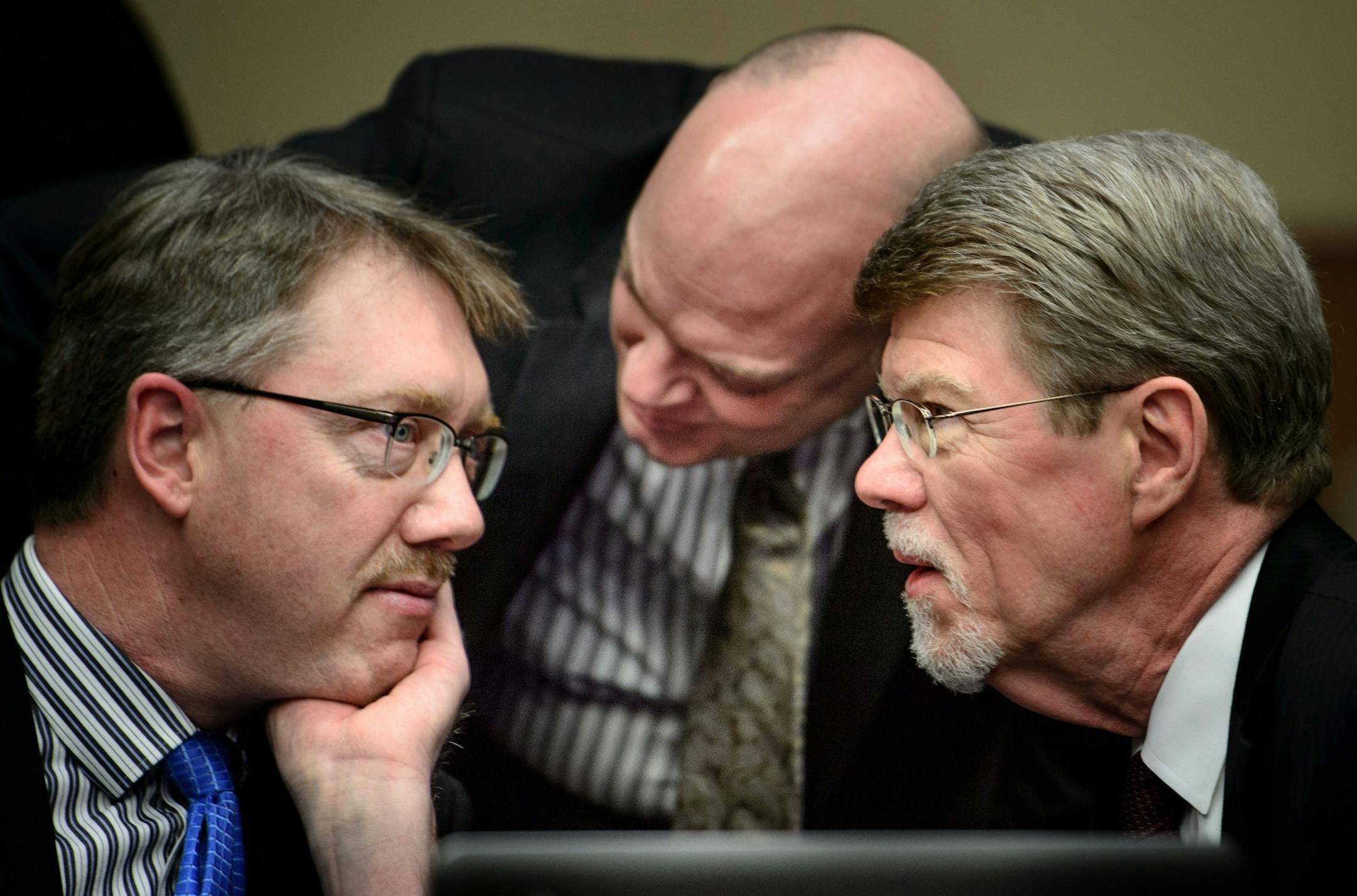 MNsure CEO Scott Leitz, center whispered to Joel Alter, legislative auditor evaluation manager, left and Legislative Auditor James Nobles, right, during a break.