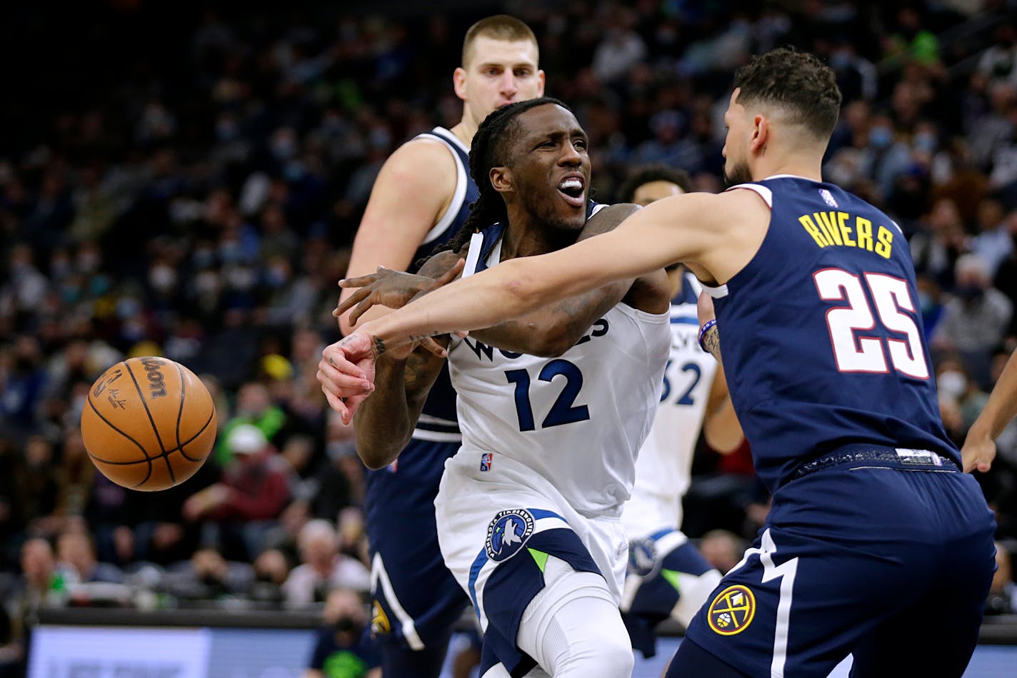 Denver Nuggets guard Austin Rivers (25) knocks the ball away from Minnesota Timberwolves forward Taurean Prince (12) during the first half of an NBA basketball game Tuesday, Feb. 1, 2022, in Minneapolis. (AP Photo/Andy Clayton-King)