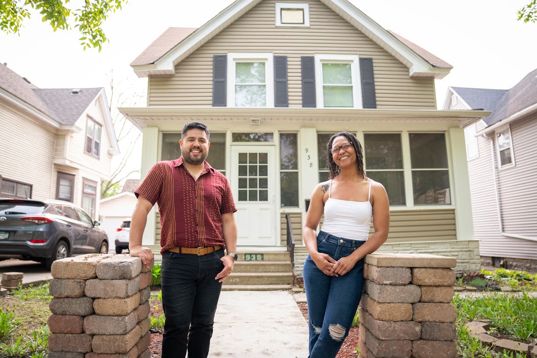 Celeste Sawyers, right, poses for a portrait with her realtor Freddy Jara outside her new home Wednesday.