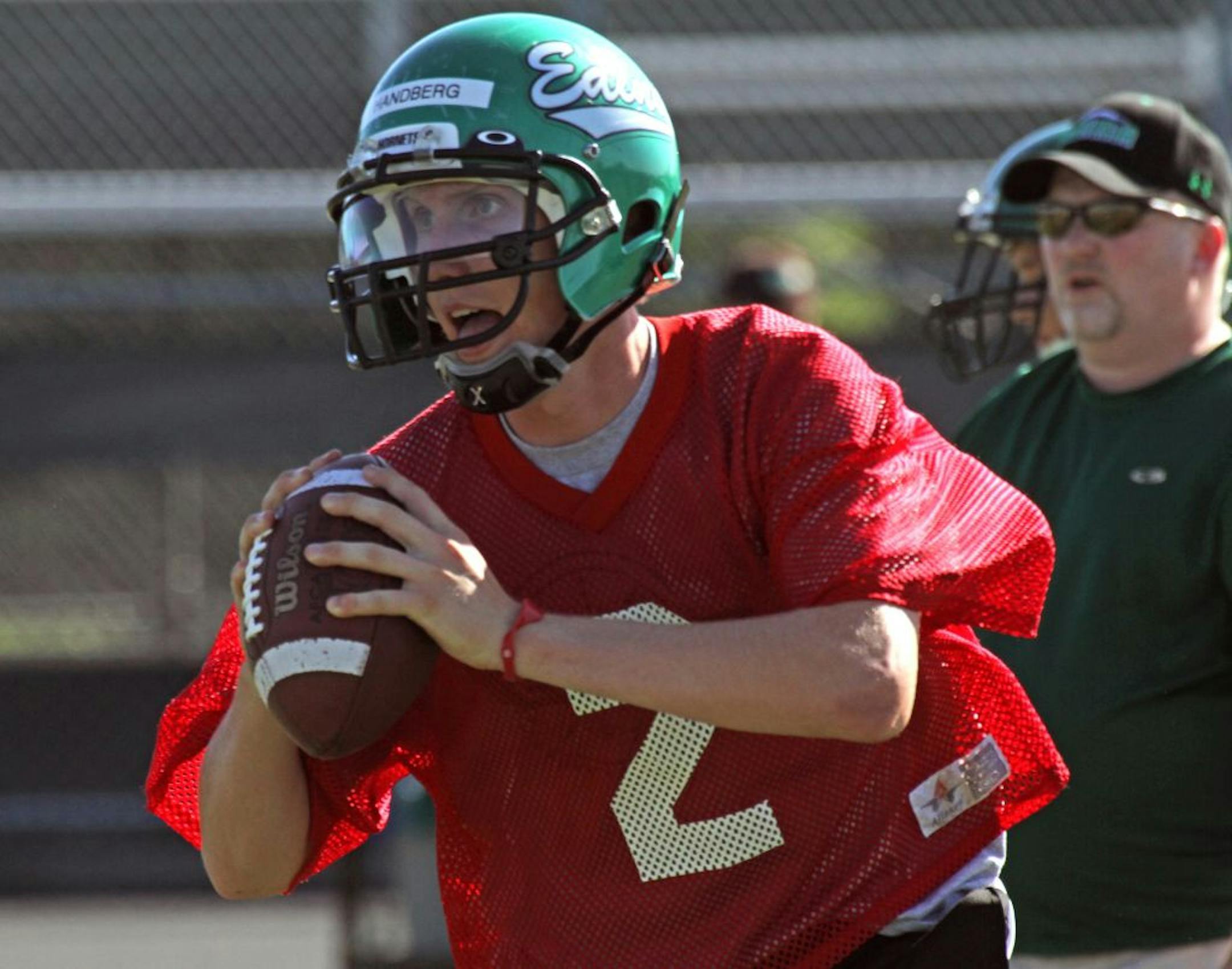 Edina Hornets quarterback Mark Handberg rolled out and looked to pass during practice at the Edina Community Center on Wednesday, 8/17/2011.