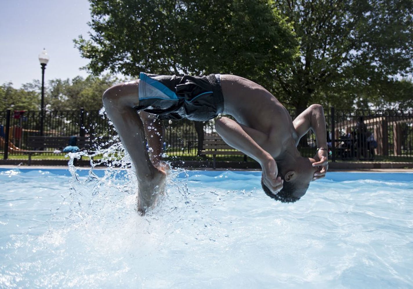 Qurdarion Phillips tried to impress his friends by doing a backflip in the pool at Victory Park on Friday as they all sought to beat the heat and humidity.