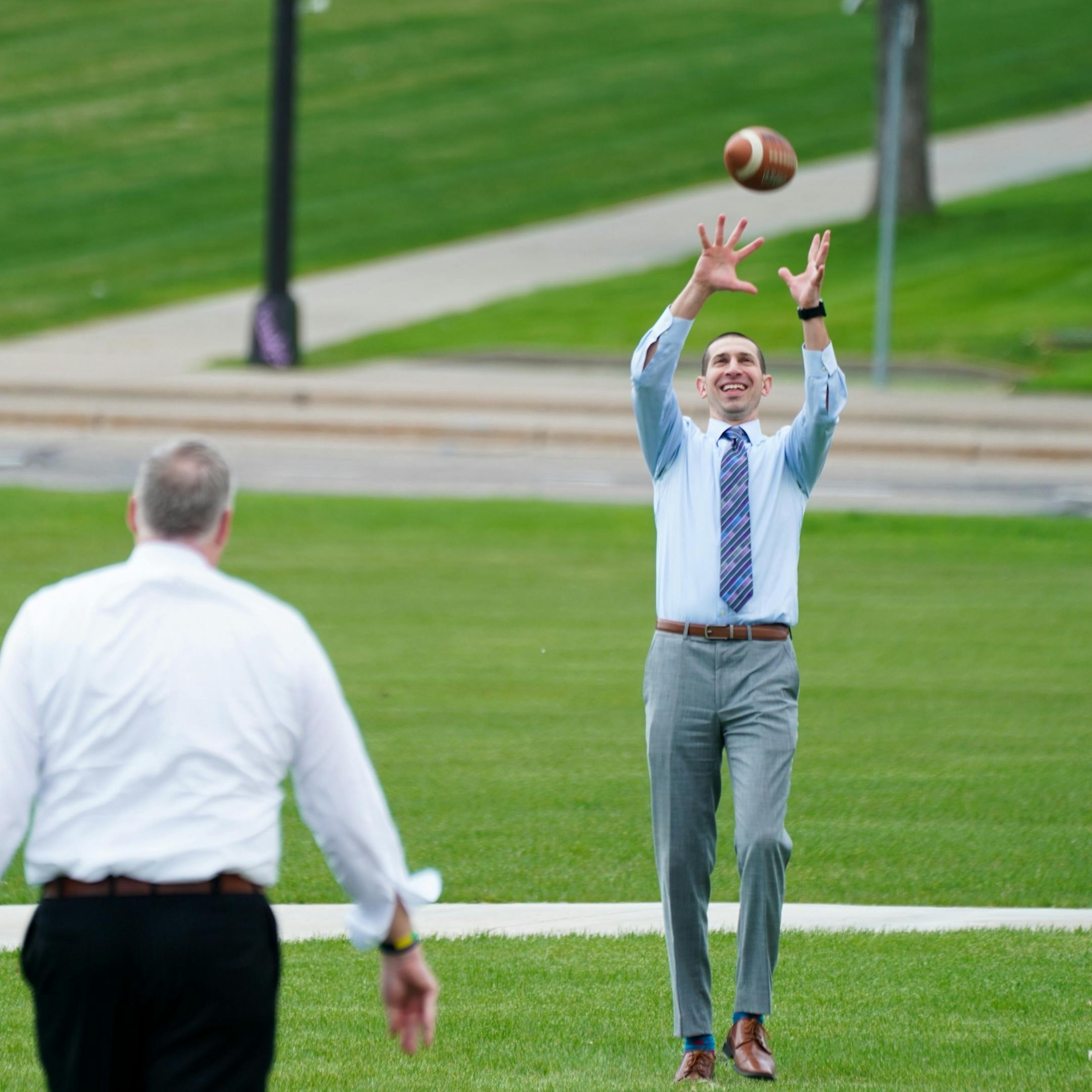 With budget negotiations stalled, Senate President Jeremy Miller, right headed to the Capitol lawn to throw a football around with Sen Paul Anderson, left and Eric Pratt.