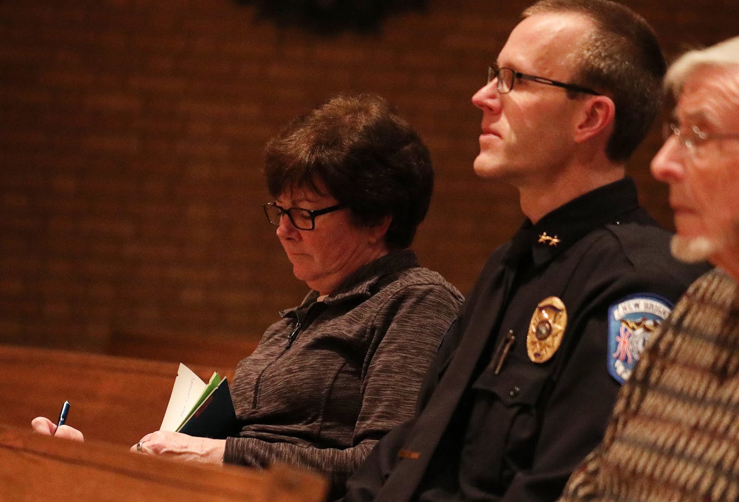 New Brighton mayor Valerie Johnson took notes during the vigil at the Christ the King Lutheran Church. ] ANTHONY SOUFFLE &#xef; anthony.souffle@startribune.com Residents at the Oak Grove Mobile Home Park and their supporters held a vigil to highlight allegations they are making against park management, including that a park employee reported residents to immigration authorities resulting in raids by ICE, Friday, Jan. 5, 2017 in New Brighton, Minn.