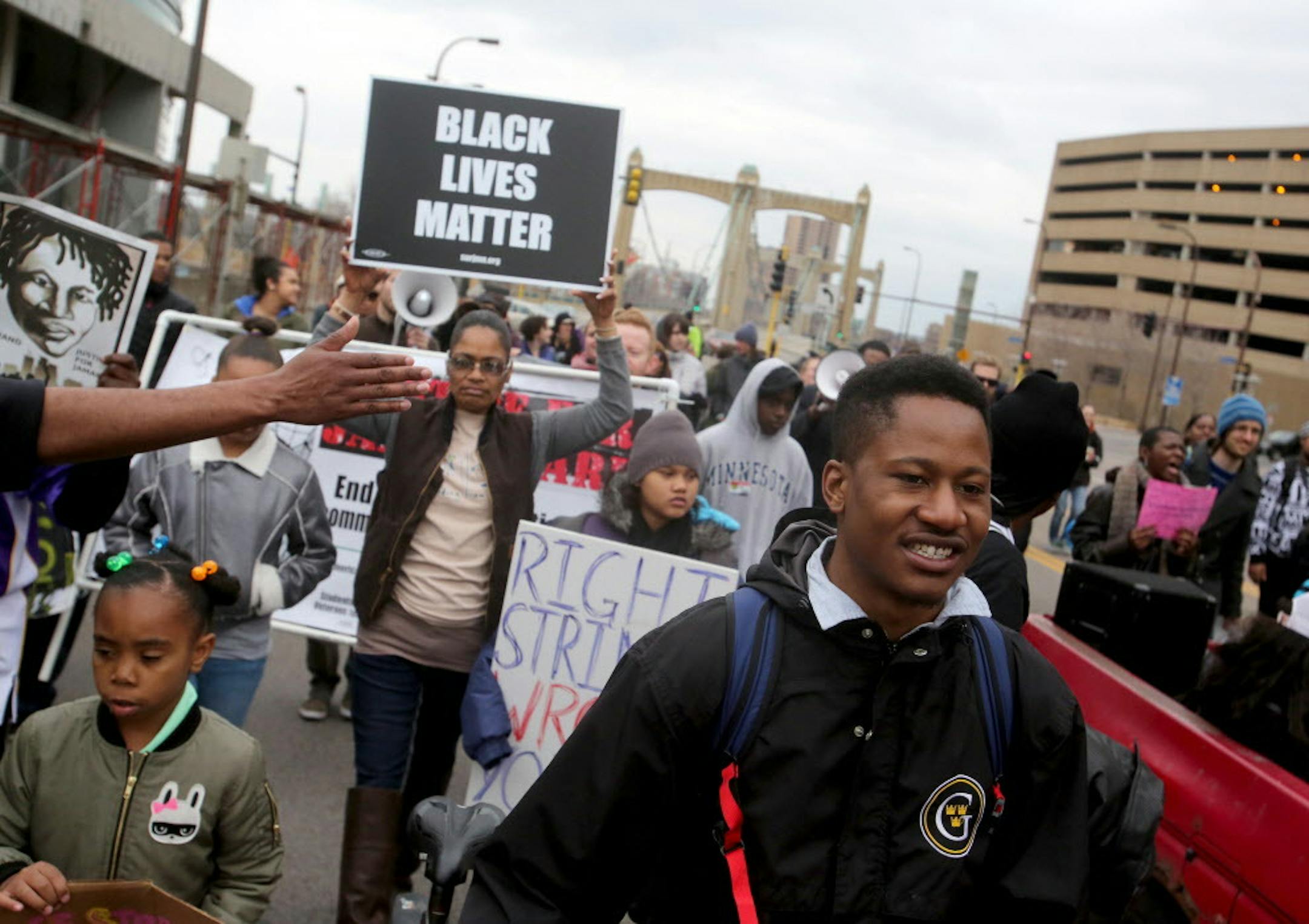 Black Lives Matter protesters head down Hennepin Ave., after converging at the County Government Center for a few hours of speakers before heading to the North Loop and back Saturday, March 26, 2016, in Minneapolis, MN.](DAVID JOLES/STARTRIBUNE)djoles@startribune.com Black Lives Matter protesters converged at the County Government Center to demand that officers Mark Ringgenberg and Dustin Schwarze, the men involved in Jamar Clark's shooting death, be charged with murder.