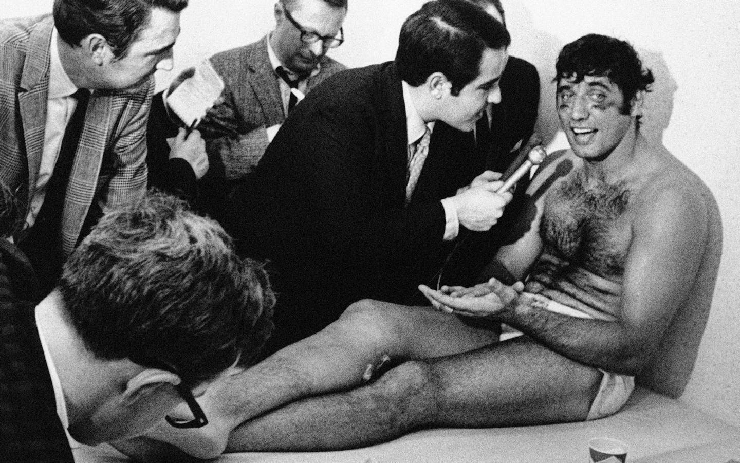 Smiling and talkative after the Super Bowl game at night New York Jets quarterback Joe Namath talks with reporters as he rests on a training table in the dressing room on Jan. 13, 1969 in Miami, Florida. Namath played most of the game completing 17 passes in 28 attempts in the 16 to 7 win over the Baltimore Colts. (AP Photo) ORG XMIT: APHS388398