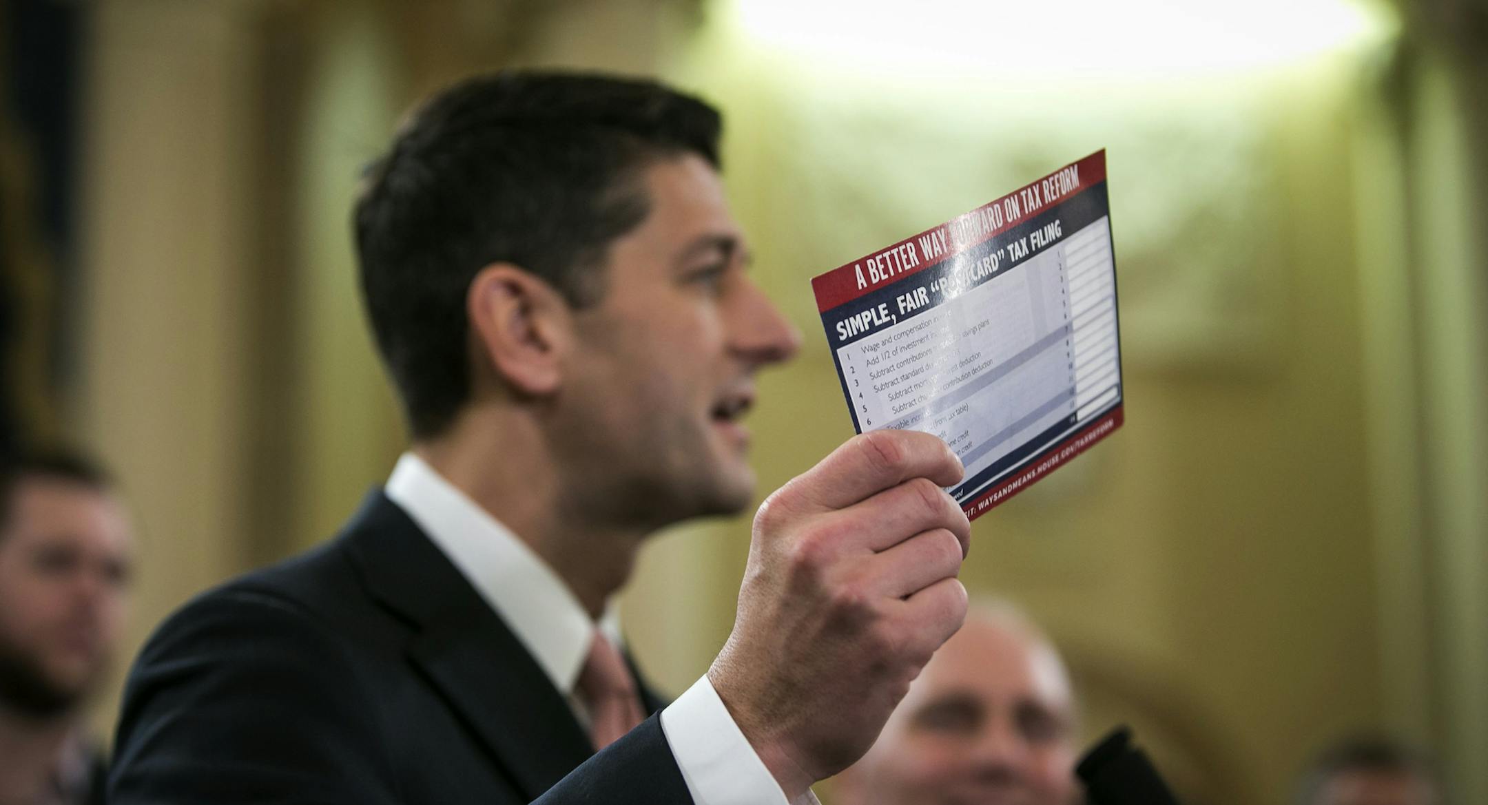House Speaker Paul Ryan (R-Wis.), accompanied by other Republican legislators, holds up an example of what a "postcard" tax return might look like during a news conference to unveil a tax reform plan, on Capitol Hill in Washington, Nov. 2, 2017. The proposal does not target the so-called carried-interest provision of the tax code. (Al Drago/The New York Times)