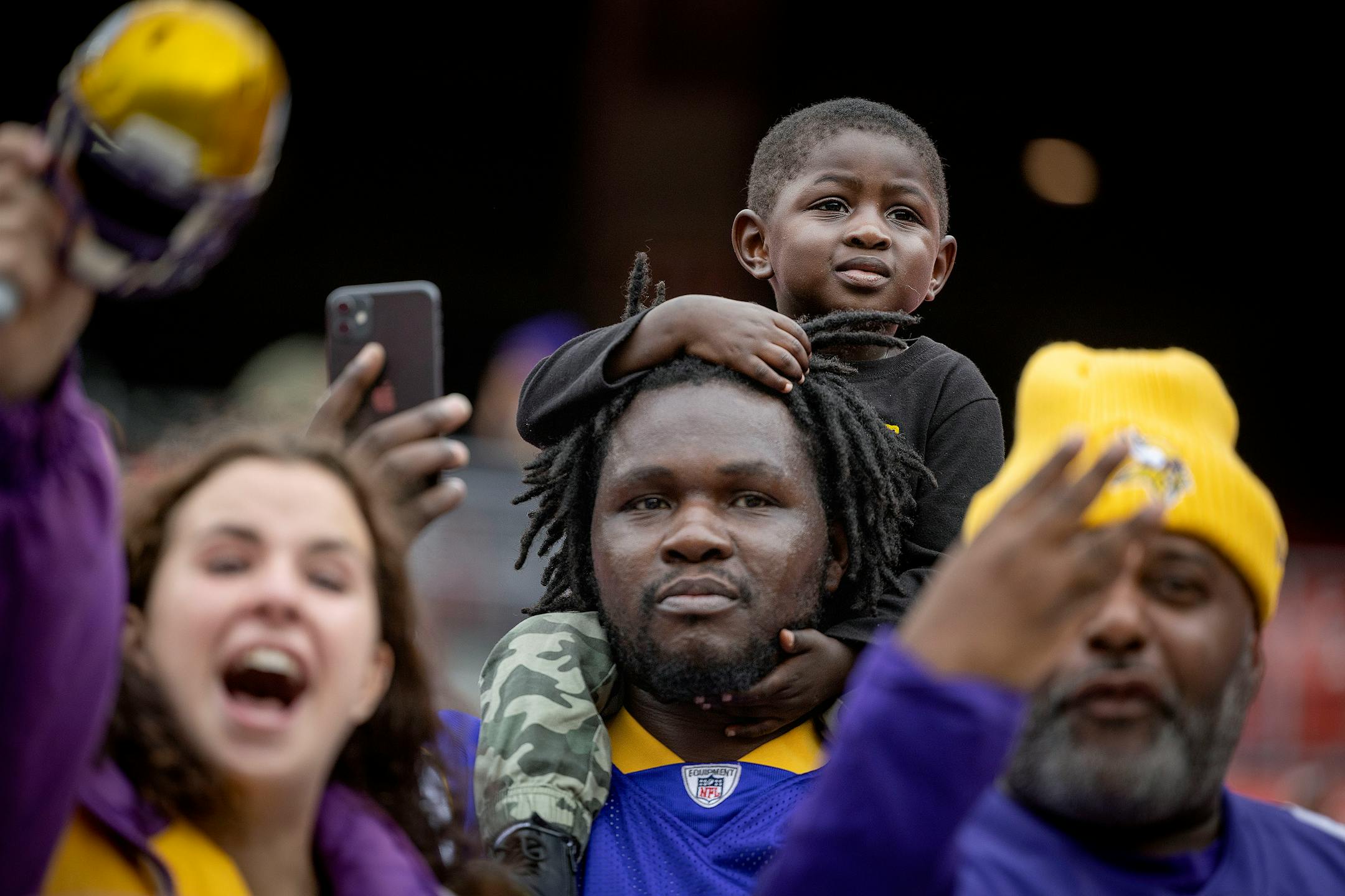 Vikings fans Trey Hill and Trey Hill Jr. watch players warm up before the Vikings take on the Washington Commanders.