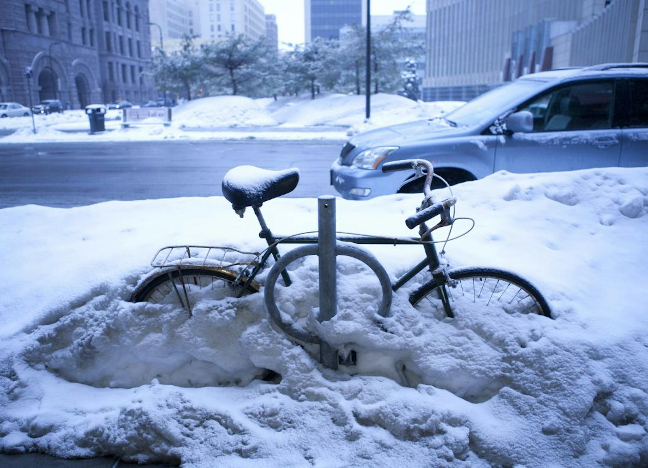 A dusting of snow showers in the morning will become more widely scattered by the afternoon. Snow accumulations expected to be less than one inch. This bicycle is patiently waiting for spring.