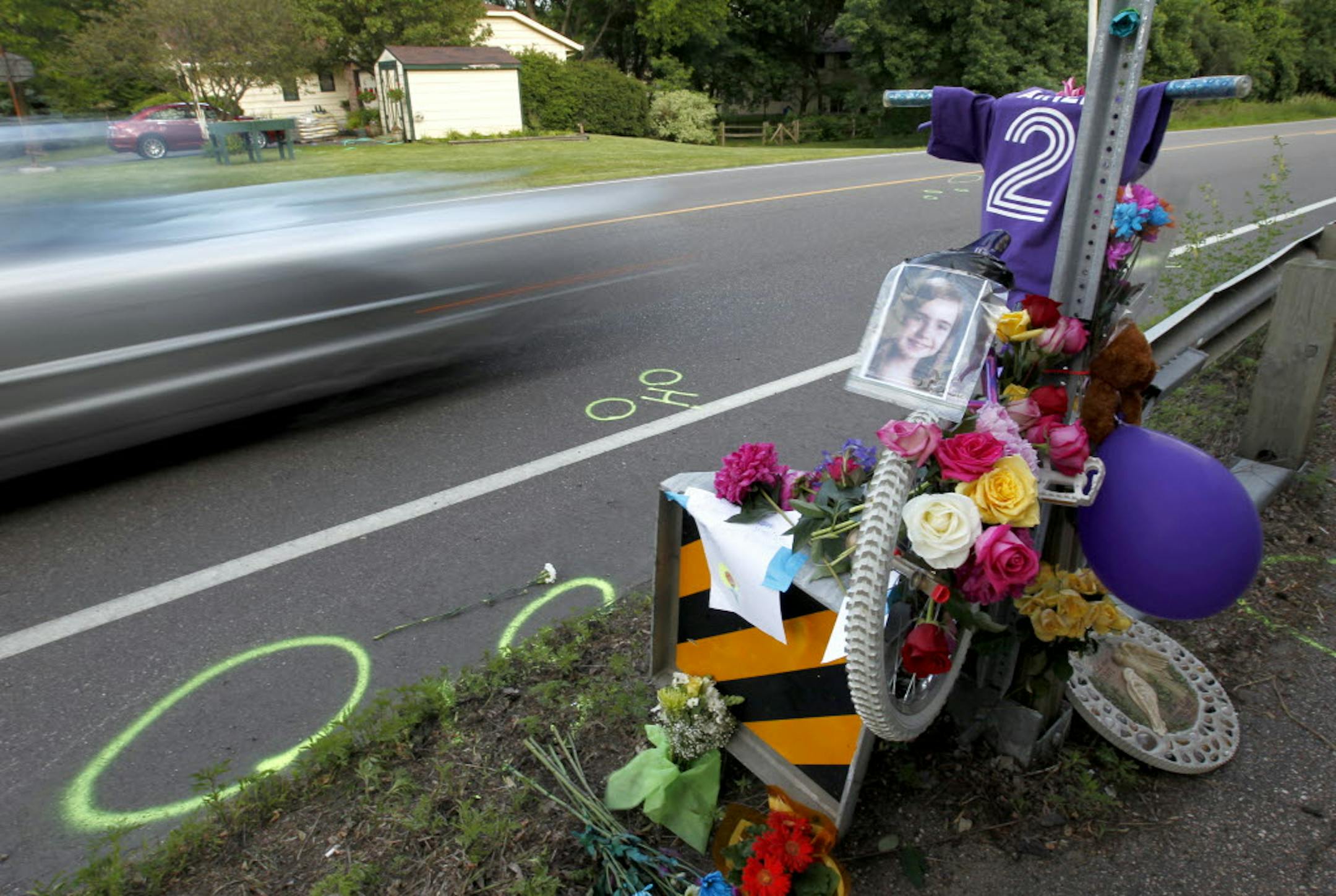 Cars on Hwy. 101 passed by a memorial for Aimee Trudeau near Sandy Hook Road in Chanhassen. The 12-year-old died after she was hit by a sport-utility vehicle while crossing the highway.