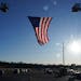 A giant American flag hung between two ladder trucks ahead of a memorial service for Burnsville police officers Paul Elmstrand, 27, Matthew Ruge, 27, 
