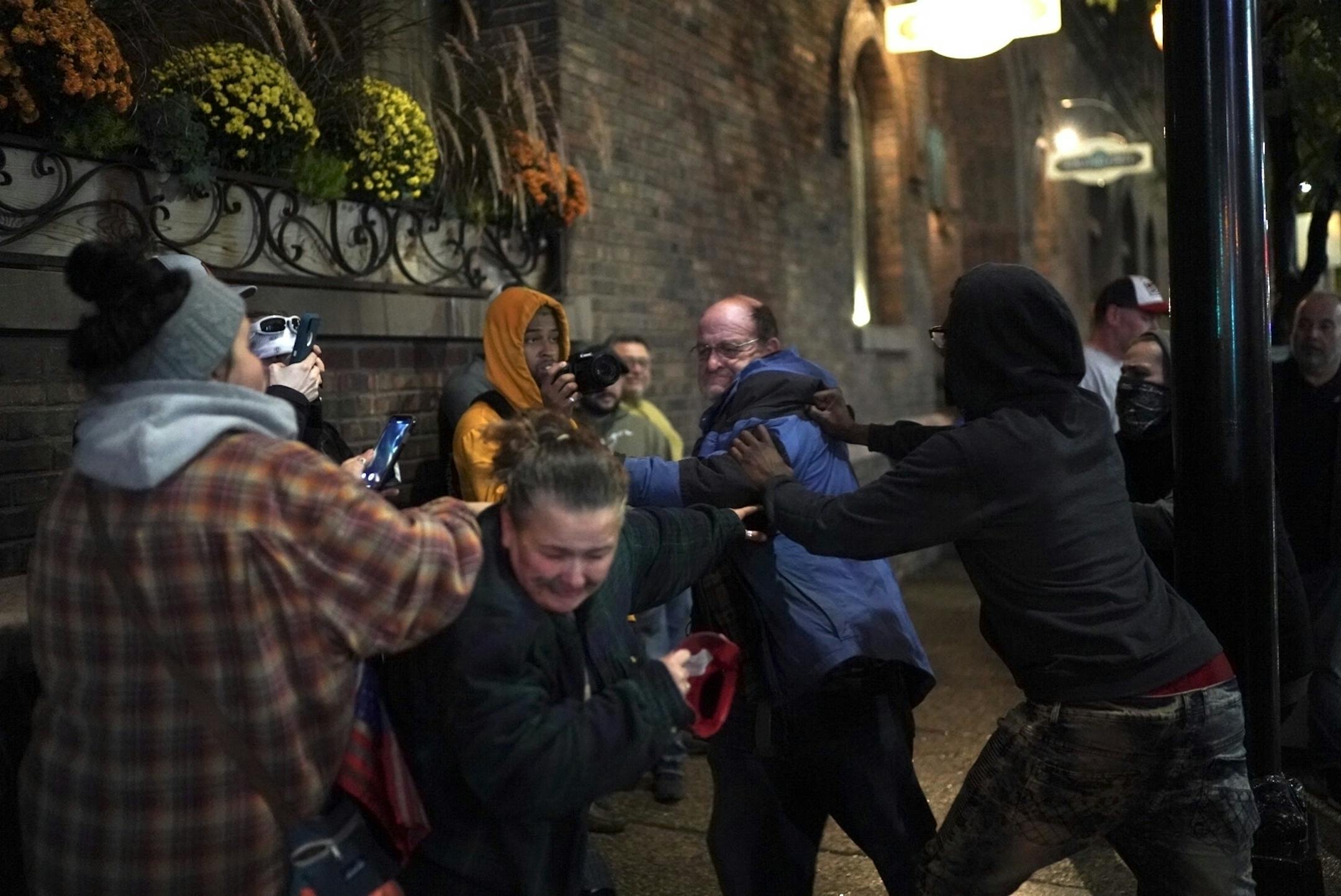 A Trump supporter got in a fight with a protester after his hat was grabbed off his head outside the Target Center after President Donald Trump visited Minneapolis, Minn., for a campaign rally on October 10, 2019. The fight appeared to escalate when he started saying "hang Obama."