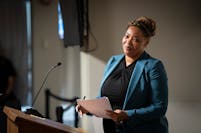 New civil rights director Michelle Phillips leaves the podium after addressing the council during a Minneapolis City Council public hearing at the Pub