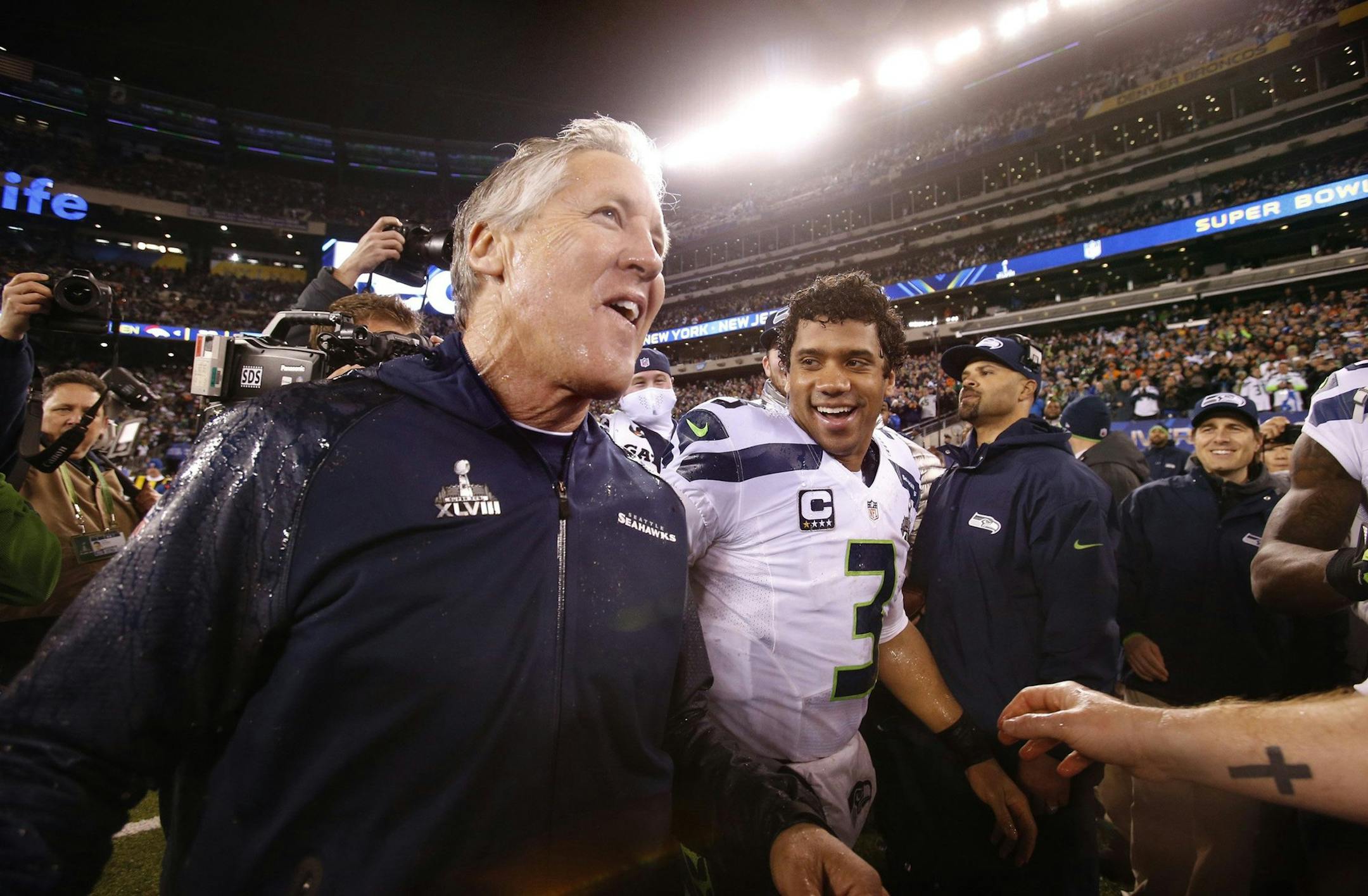 Seattle Seahawks head coach Pete Carroll and quarterback Russell Wilson celebrate after a 43-8 victory against the Denver Broncos in Super Bowl XLVIII at MetLife Stadium in East Rutherford, N.J., on Sunday, Feb. 2, 2014. (Tony Overman/The Olympian/MCT)