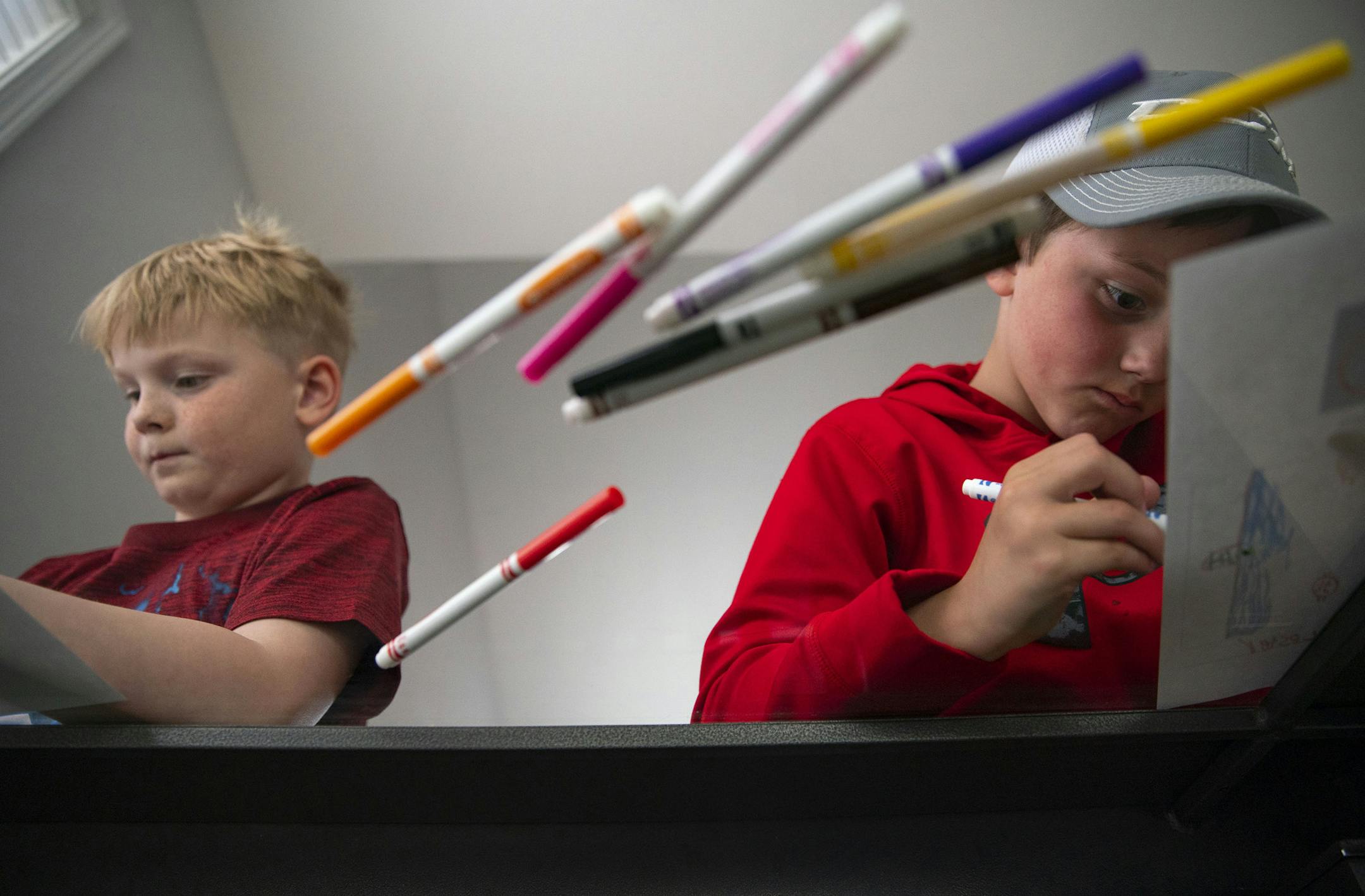 (Left) Friends Grant Danielski (8) and Cooper Chick (8) worked on designing a mask with a soccer field and hockey rink on them, respectively. They are both huge fans of hockey and spend time each day outside shooting pucks. ] ALEX KORMANN • alex.kormann@startribune.com The City of Duluth is asking local kids to draw and color face mask designs at home. A few of the best ones will be selected to be printed on real masks that will be handed out in the community.