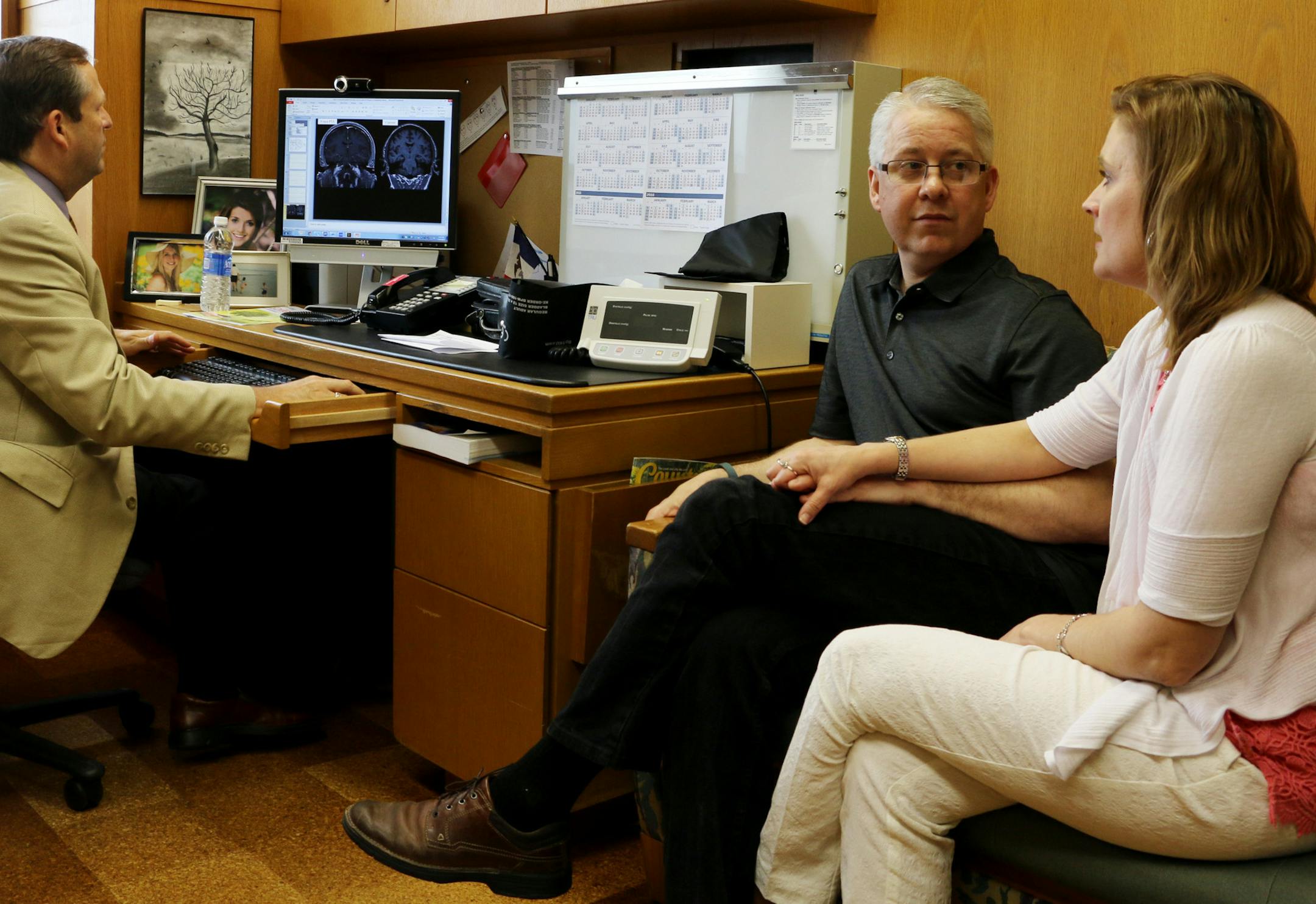 Dr. Jeffrey Britton, a Mayo Clinic neurologist, explains that some minor electrical abnormalities were found in the temporal lobes of Polk County Attorney Greg Widseth, center, who suffered seizures a year ago from an unexplained autoimmune epilepsy disorder. &#xec;Getting here quickly made a huge difference,&#xee; Britton told Widseth&#xed;s wife Nan, a nurse who arranged for her husband to be seen promptly at Mayo. ] Dan Browning/Star Tribune