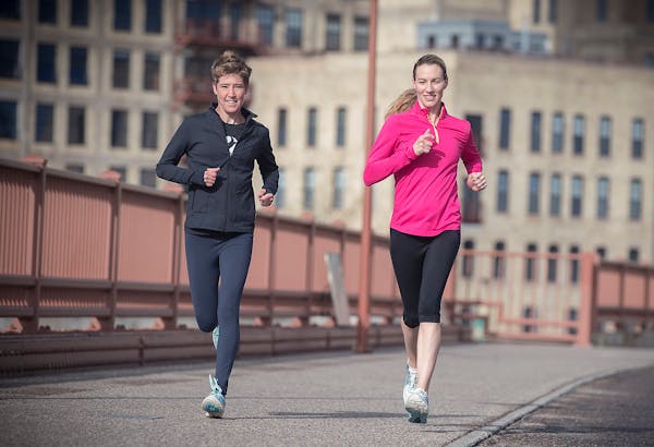 Running icon Carrie Tollefson, right, made her way across the Stone Arch Bridge for an early morning run May 2, 2017.