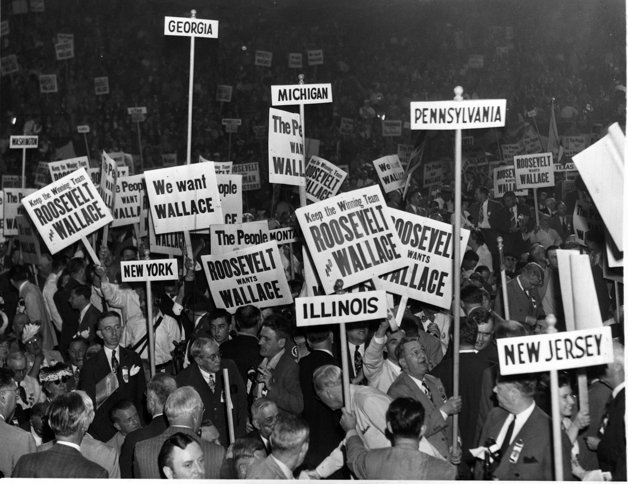 DEMOCRATIC NATIONAL CONVENTION, July 1944, Chicago. Despite convention floor clamor in support of incumbent vice president Henry Wallace as running mate for Pres. Franklin Roosevelt, party bosses pushed for another candidate. Harry S. Truman was chosen, and became president when FDR died in April 1945. In this photo, deep left center, note the sign for Roosevelt & Truman, and, even deeper center right, a Truman sign, among the sea of Wallace supporters during the demonstration that followed the