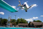 Berk Benson, 13, of Burnsville jumps off the diving board at Redwood Community Pool in Apple Valley, Minn. on Friday, June 14, 2024. Apple Valley, whi