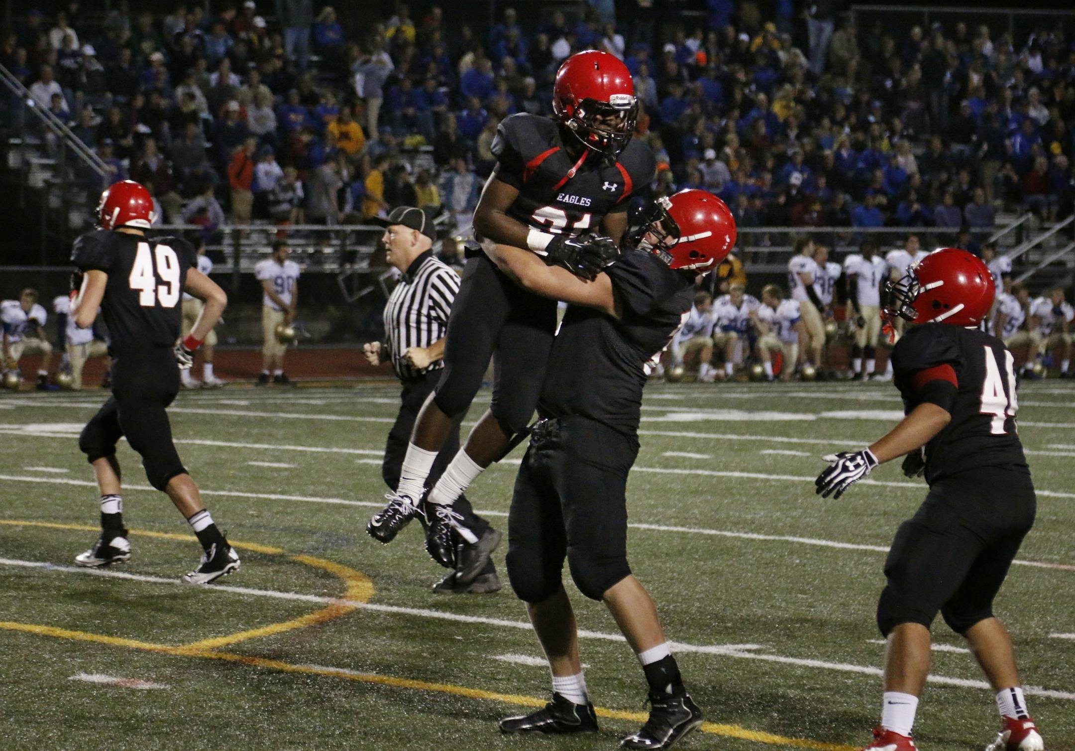 Eden Prairie's Ray Wilson (top) celebrates his TD in the 1st quarter. Eden Prairie was leading Wayzata 42-7 at the half.