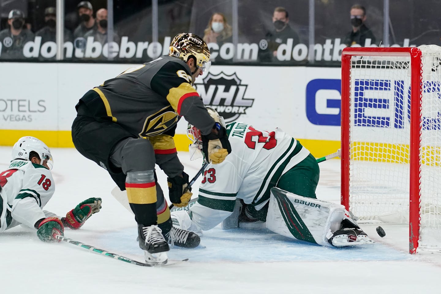 Vegas Golden Knights left wing Max Pacioretty (67) scores against Minnesota Wild goaltender Cam Talbot (33) during overtime of an NHL hockey game Monday, March 1, 2021, in Las Vegas. (AP Photo/John Locher)