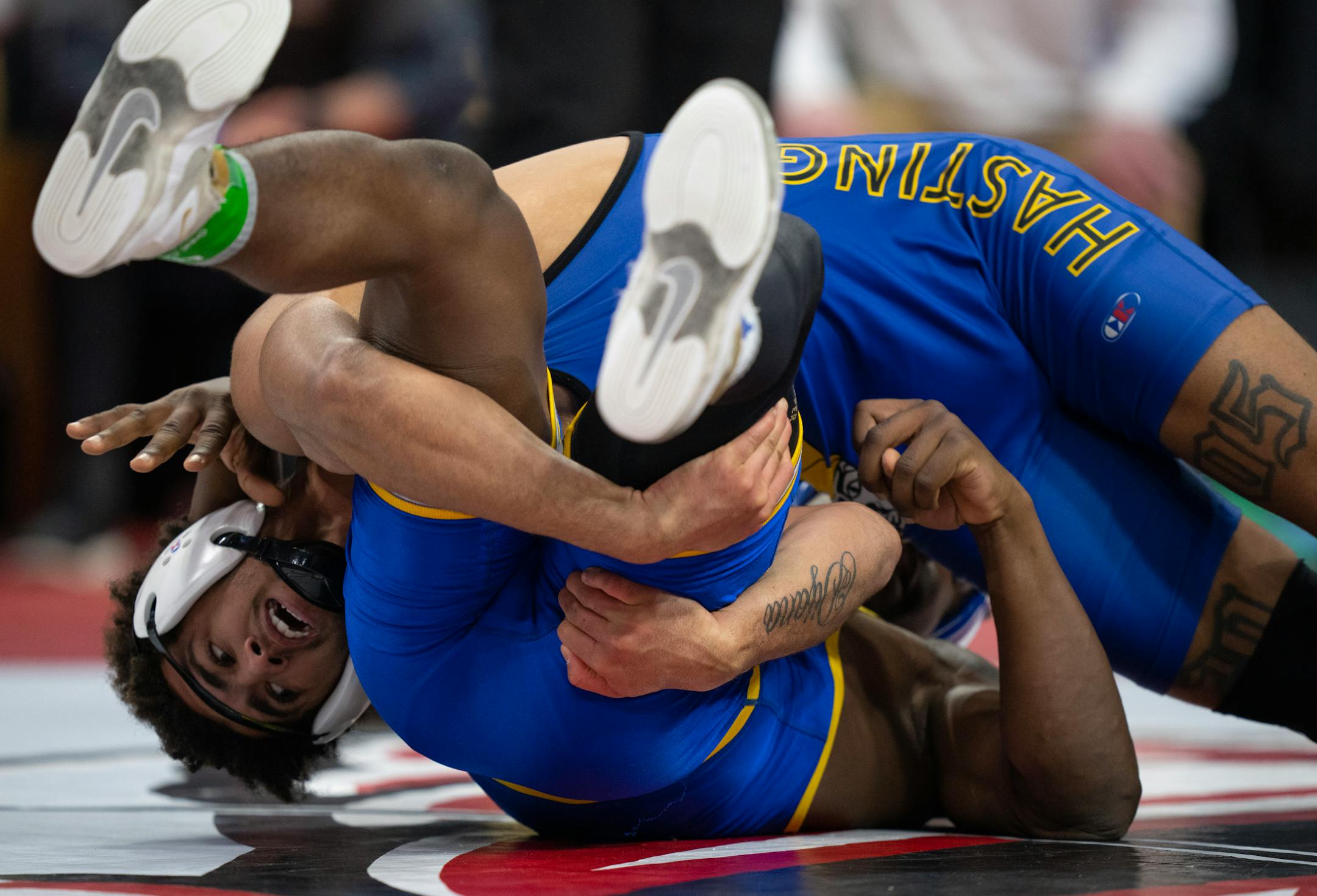 Jericho Cooper of Hastings, left, on his way to a 14-8 decison over Bryon Sauvy of St. Michael-Albertville in their 182 lb. match.