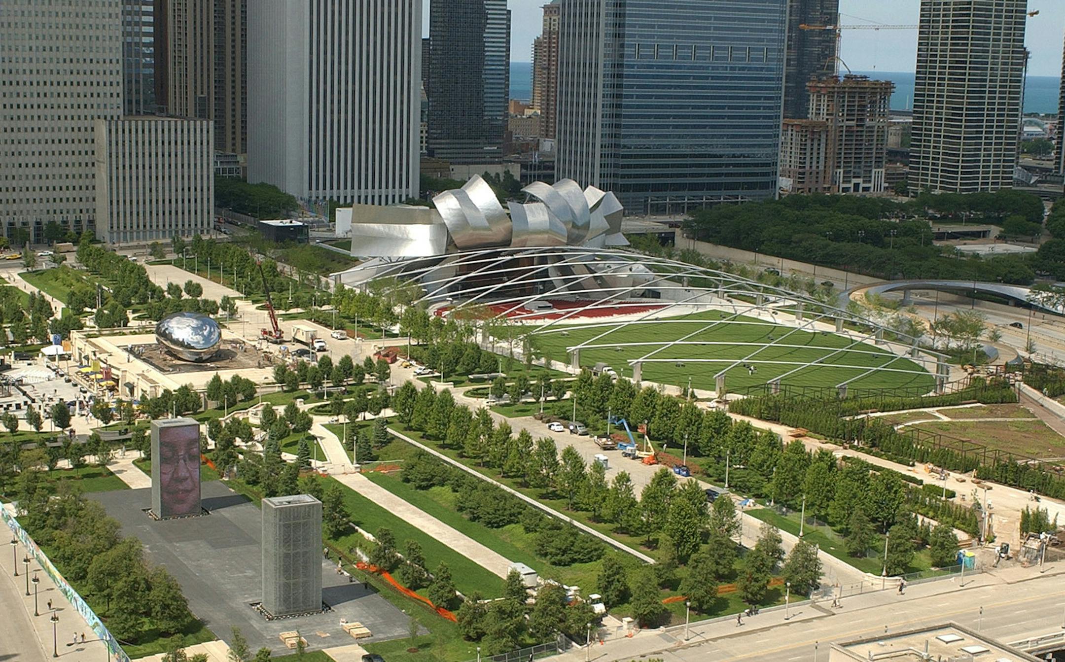 An overhead view shows the 24-acre, $475 million Millennium Park in Chicago, on July 8, 2004. Located between Lake Michigan and bustling Michigan Avenue, the site used to be a rail yard and parking lot that marred the northwest corner of otherwise elegant Grant Park. Four years behind schedule, the park is set to officially open Friday night, July 16, with a fountain, elaborate gardens and a swooping, shimmering band shell designed by architect Frank Gehry. (AP Photo/Chicago Sun-Times Jim Frost)