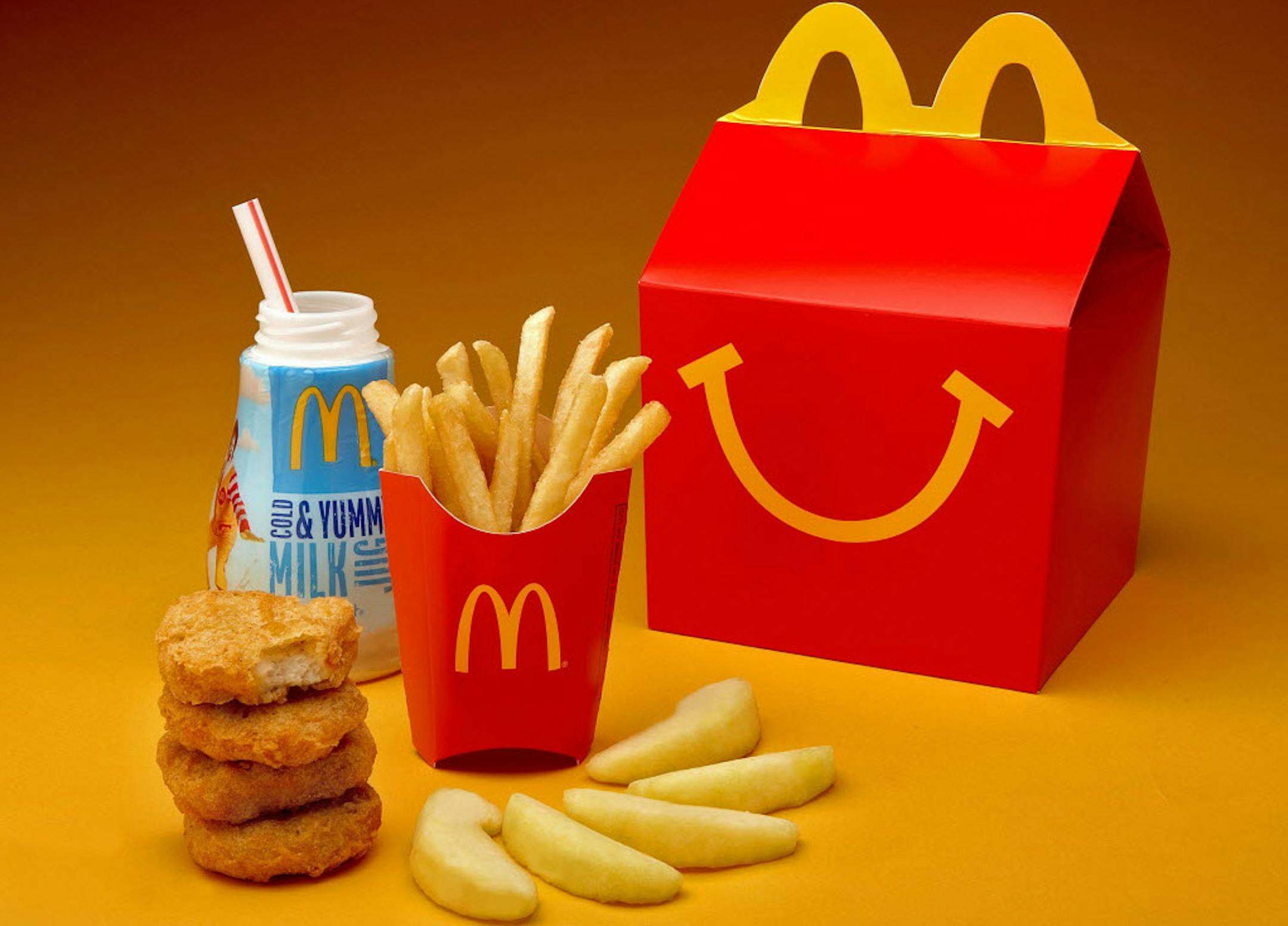 McDonald's new Happy Meal will automatically include both produce (apple slices) and a new smaller size French fries (1.1 ounces) and a choice of beverage, including new fat-free chocolate milk and 1% low fat white milk.